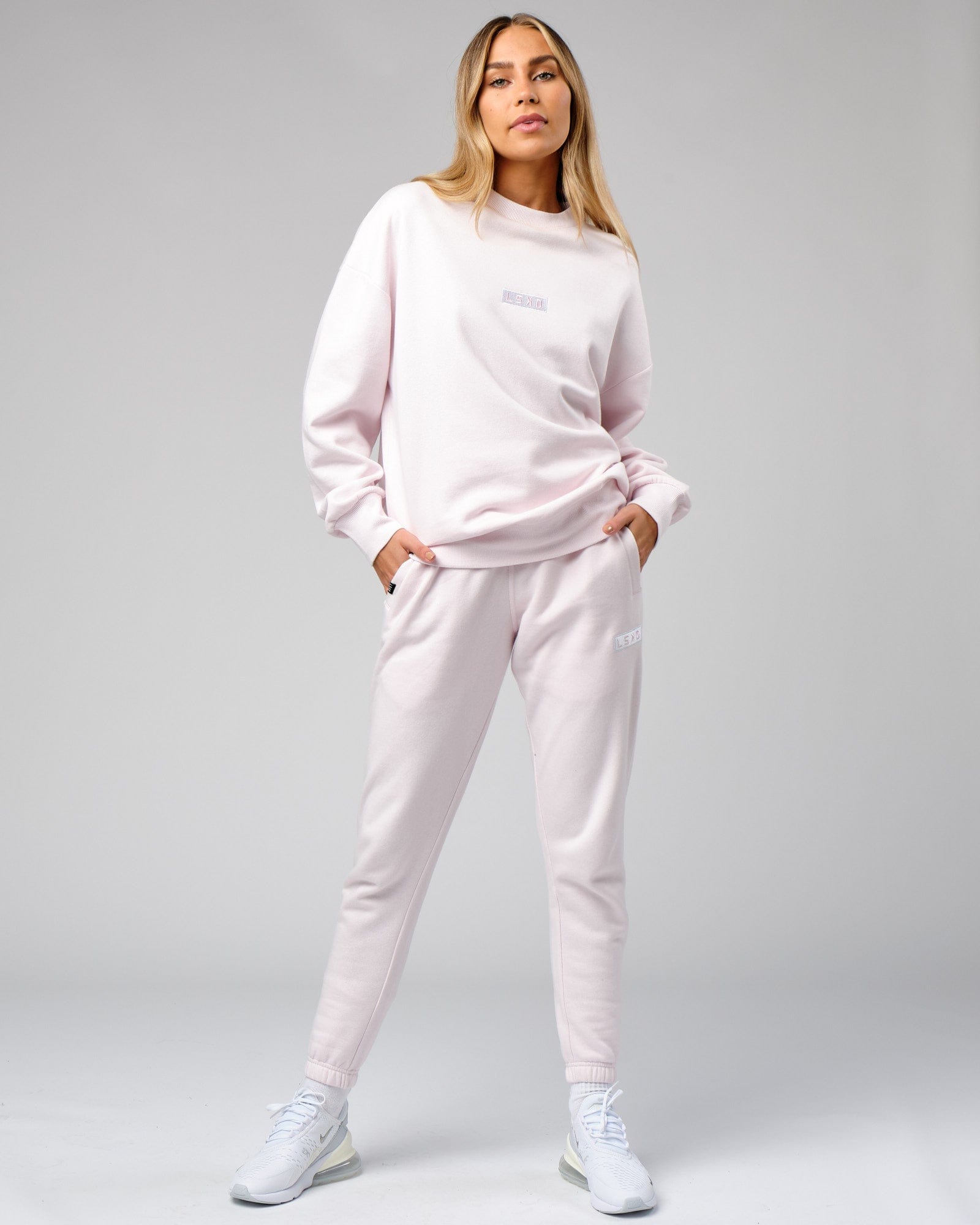 Model wearing Unisex Cornerstone Track Pant Oversize - Orchid Ice