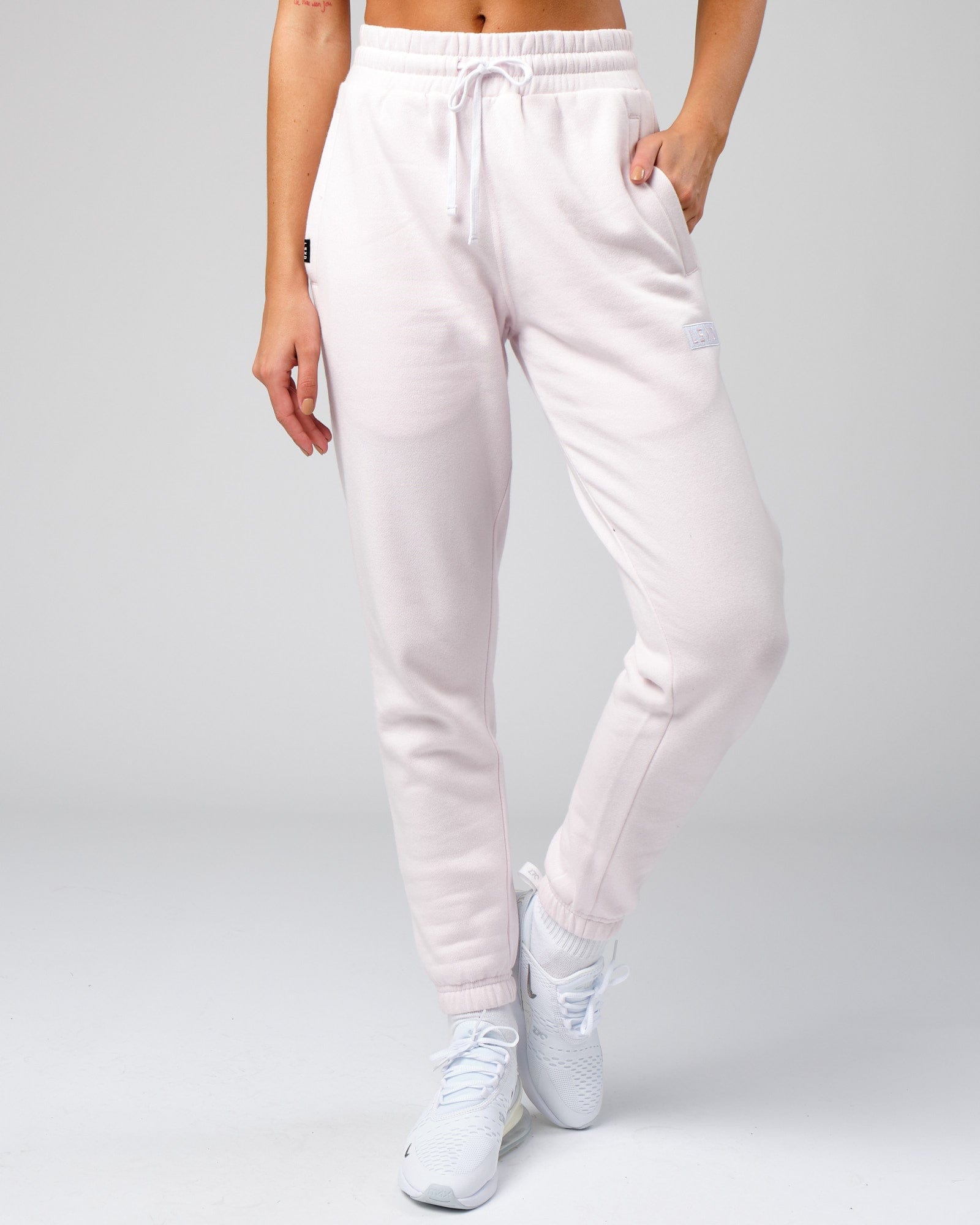 Model wearing Unisex Cornerstone Track Pant Oversize - Orchid Ice