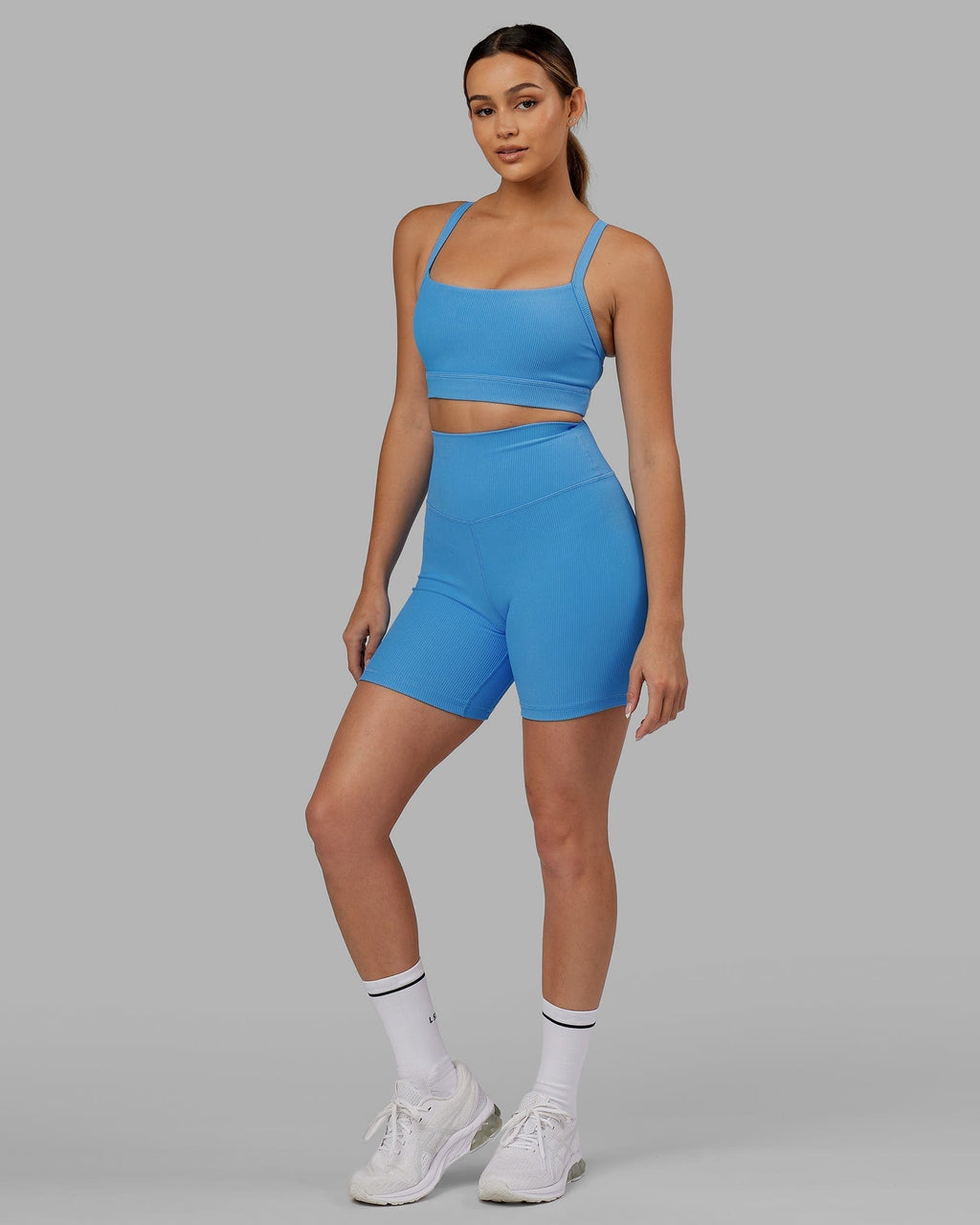Model wearing Strike Ribbed Mid Short Tights - Azure Blue
