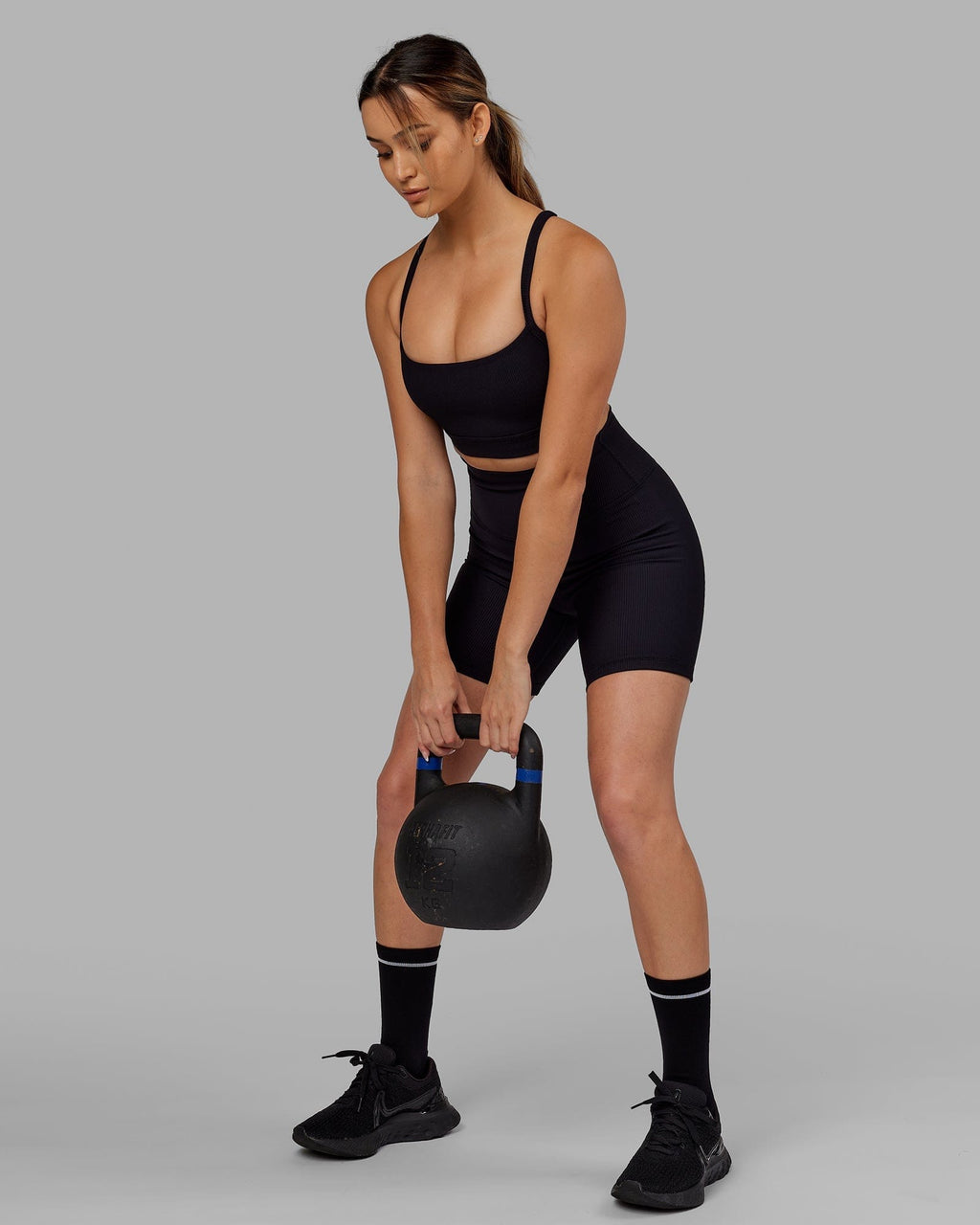 Model wearing Strike Ribbed Mid Short Tights - Black