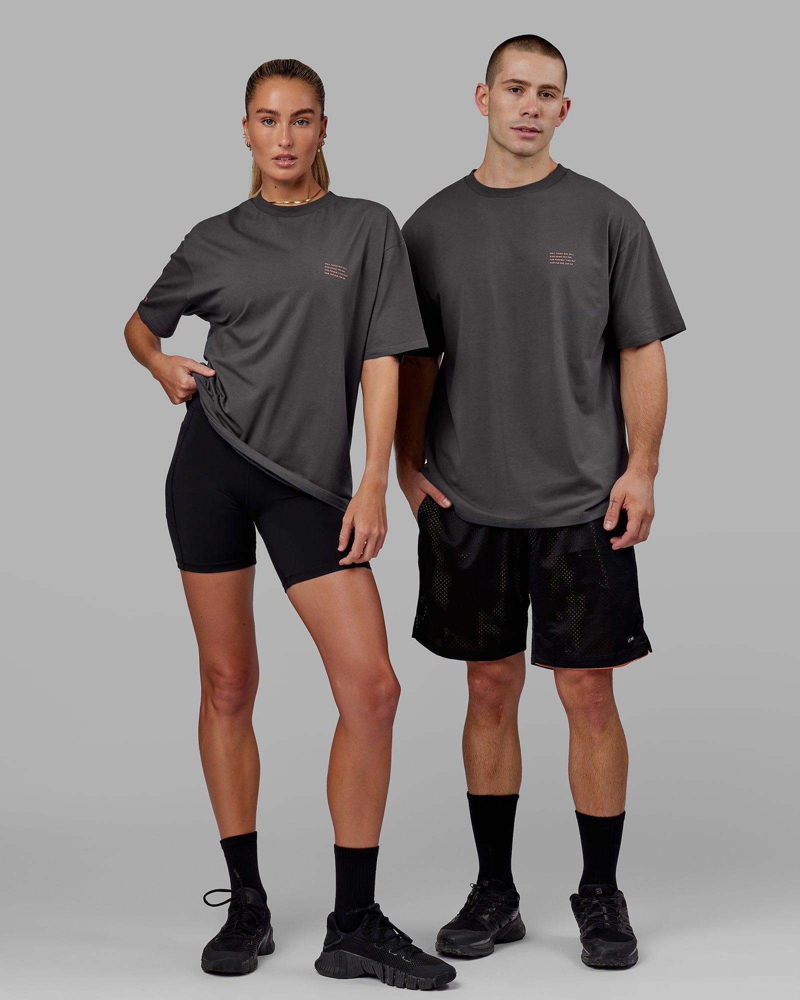 Model wearing Unisex Strive FLXCotton Tee Oversize - Asphalt-Tangerine