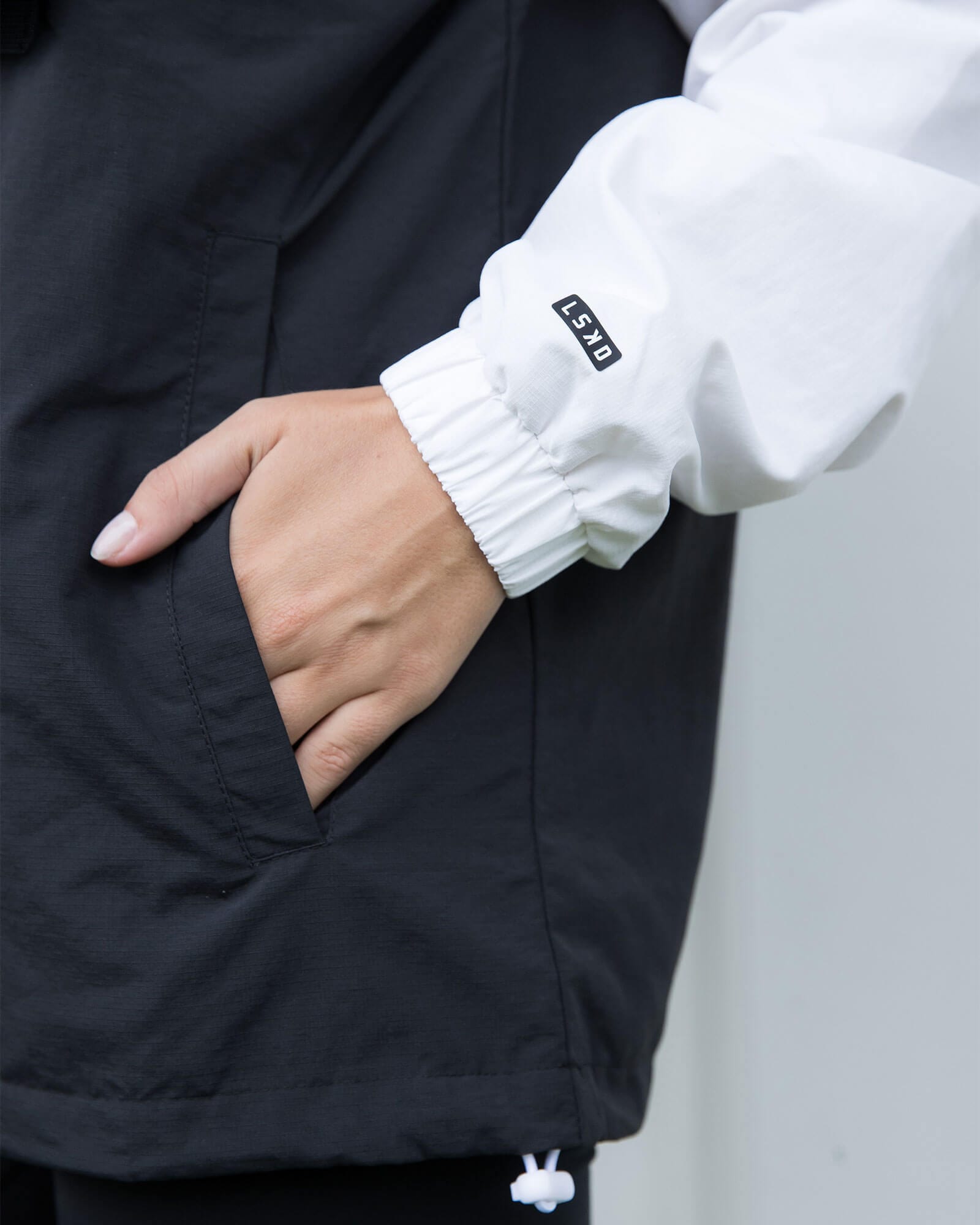 Model wearing Unisex Speedster Packable Track Jacket Oversize - Black-White