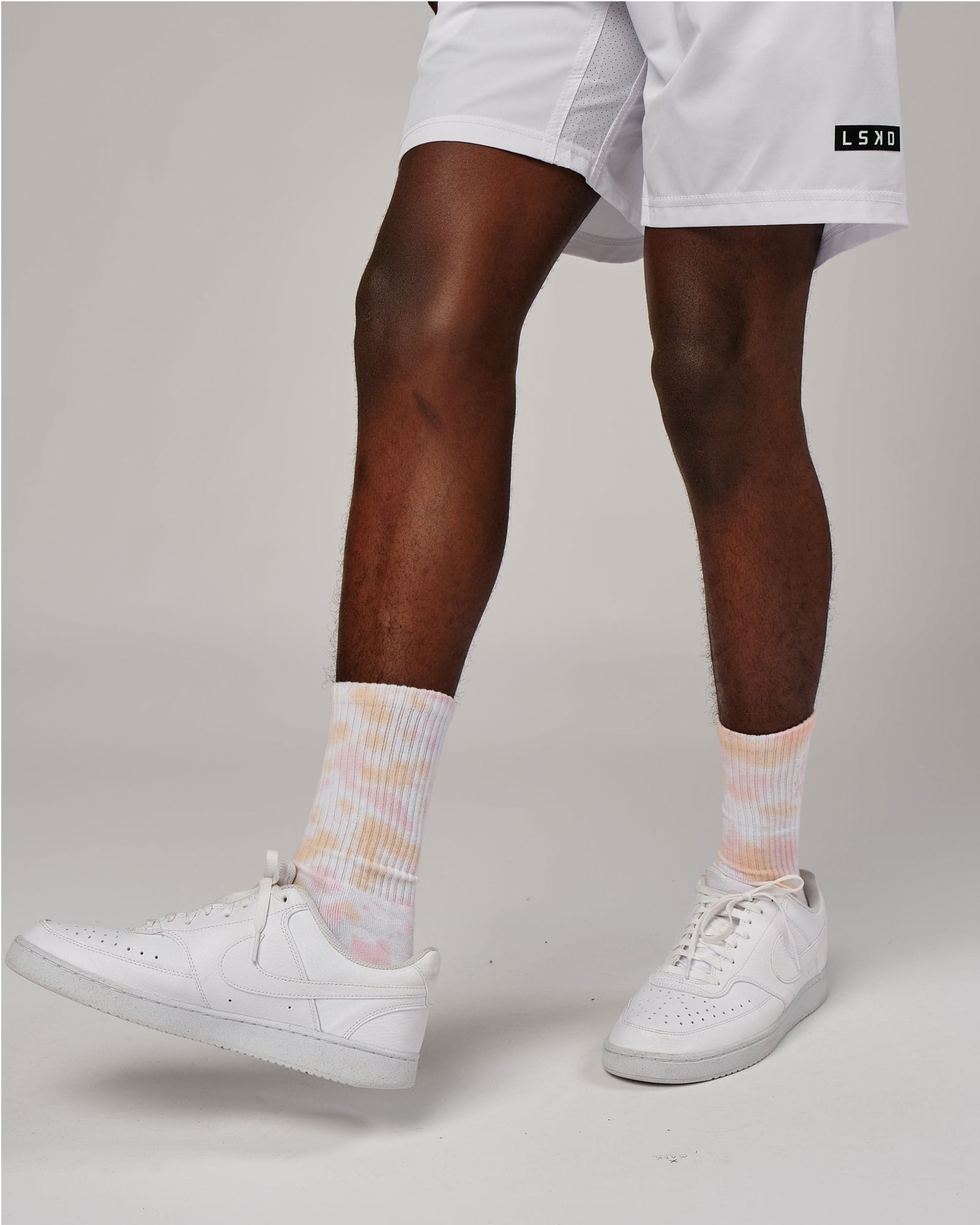 Model wearing Signal Crew Sock - Tutti Frutti Tie Dye