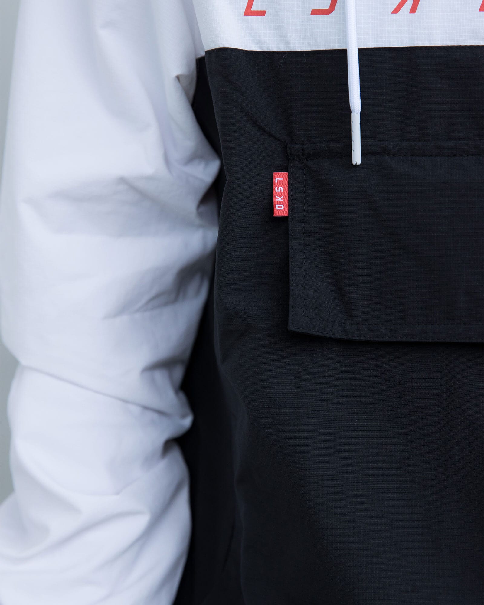 Model wearing Unisex Speedster Packable Track Jacket Oversize - Black-White