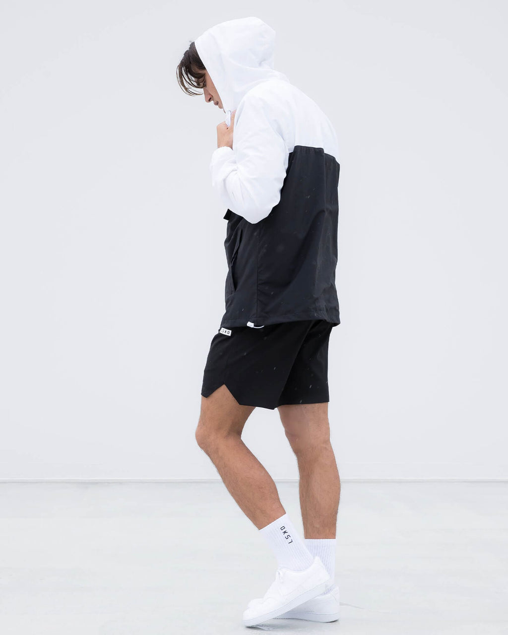 Model wearing Unisex Speedster Packable Track Jacket Oversize - Black-White