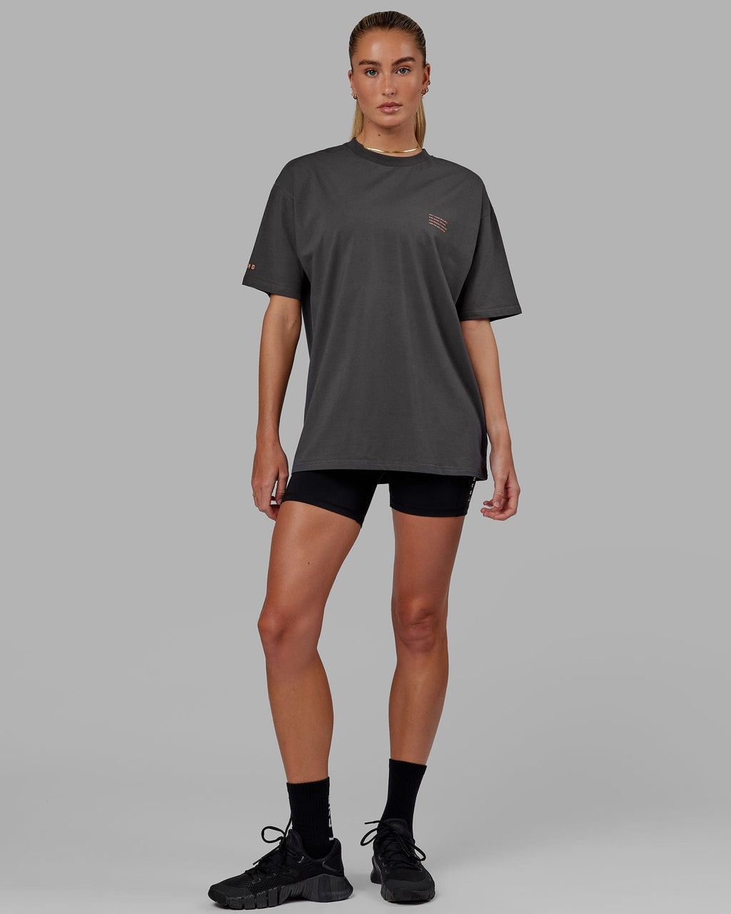 Model wearing Unisex Strive FLXCotton Tee Oversize - Asphalt-Tangerine