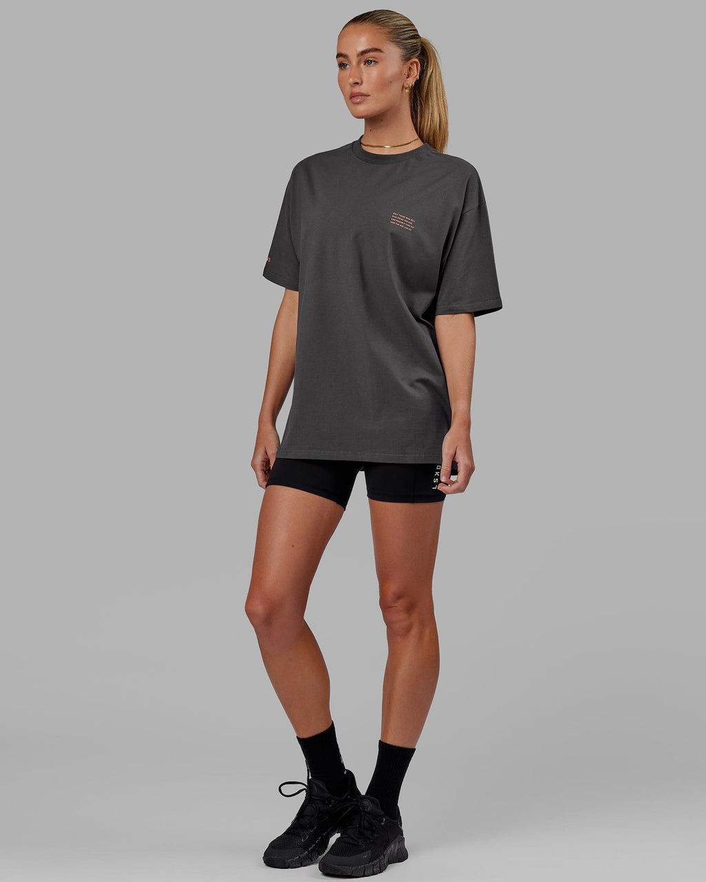 Model wearing Unisex Strive FLXCotton Tee Oversize - Asphalt-Tangerine