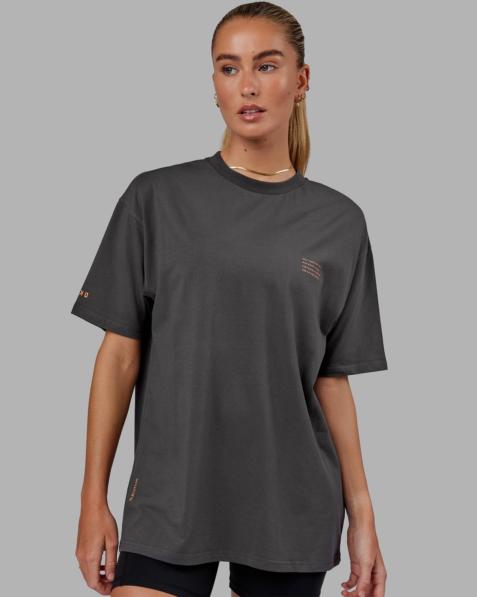Model wearing Unisex Strive FLXCotton Tee Oversize - Asphalt-Tangerine