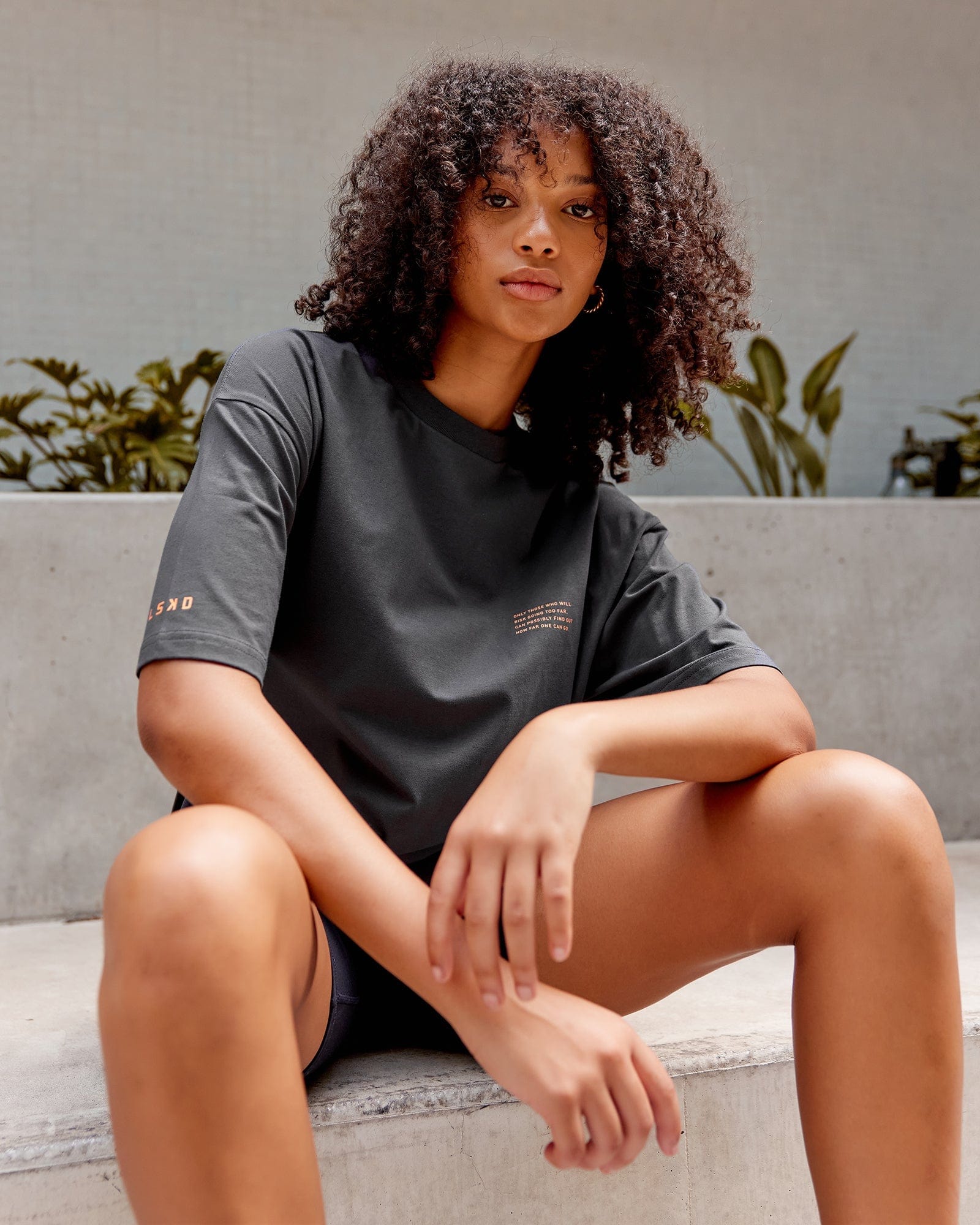 Model wearing Unisex Strive FLXCotton Tee Oversize - Asphalt-Tangerine