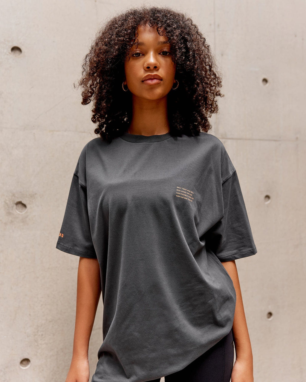 Model wearing Unisex Strive FLXCotton Tee Oversize - Asphalt-Tangerine