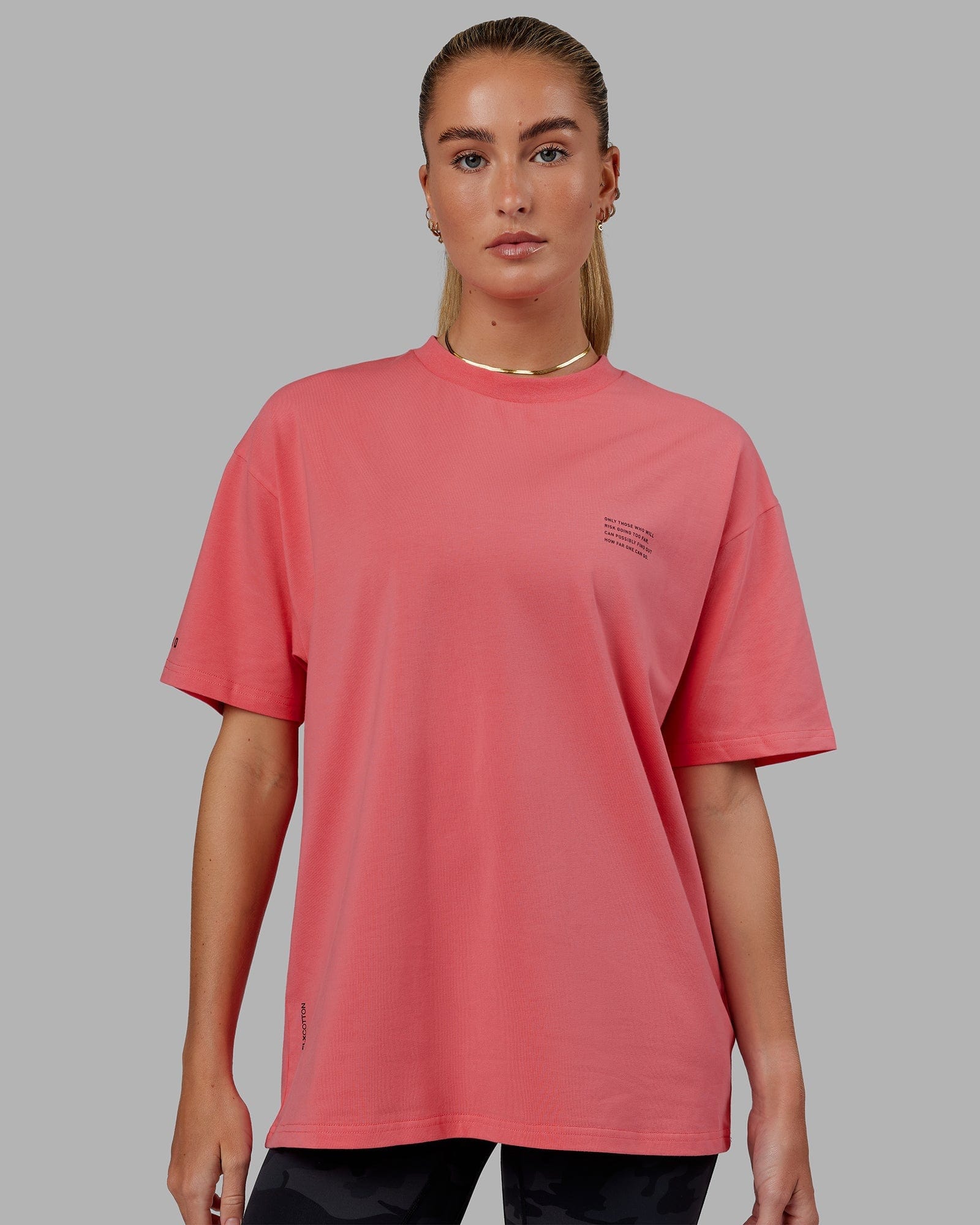 Model wearing Unisex Strive FLXCotton Tee Oversize - Sunkist Coral