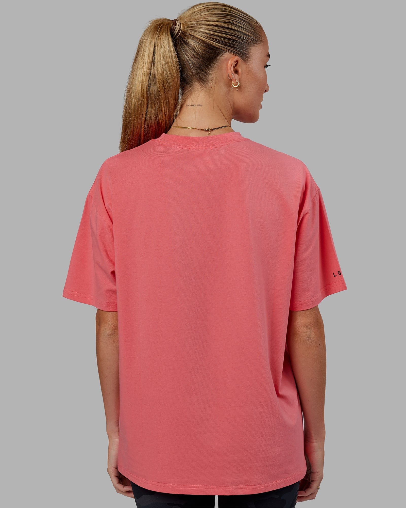 Model wearing Unisex Strive FLXCotton Tee Oversize - Sunkist Coral