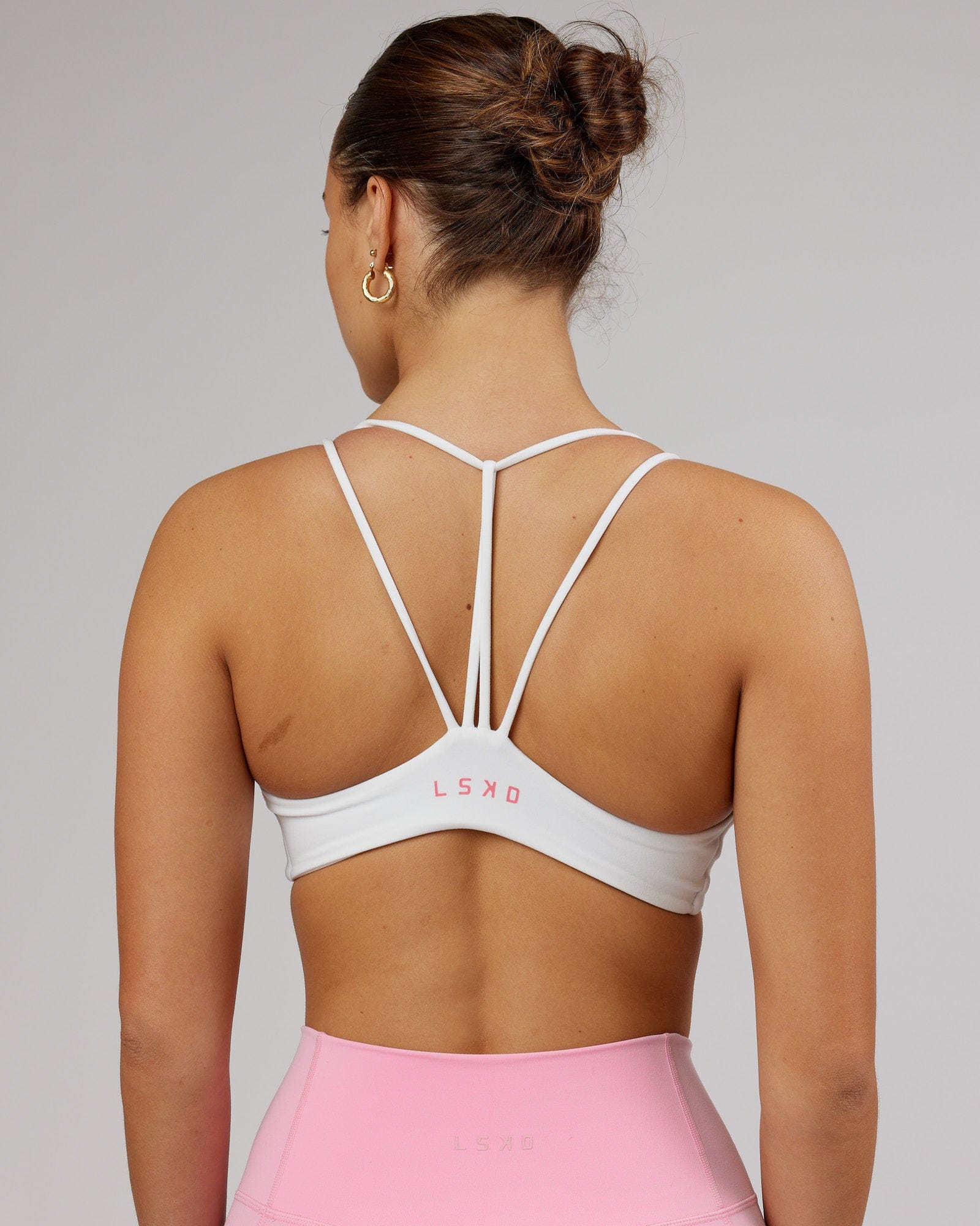Model wearing Agile Sports Bra - White-Flamingo