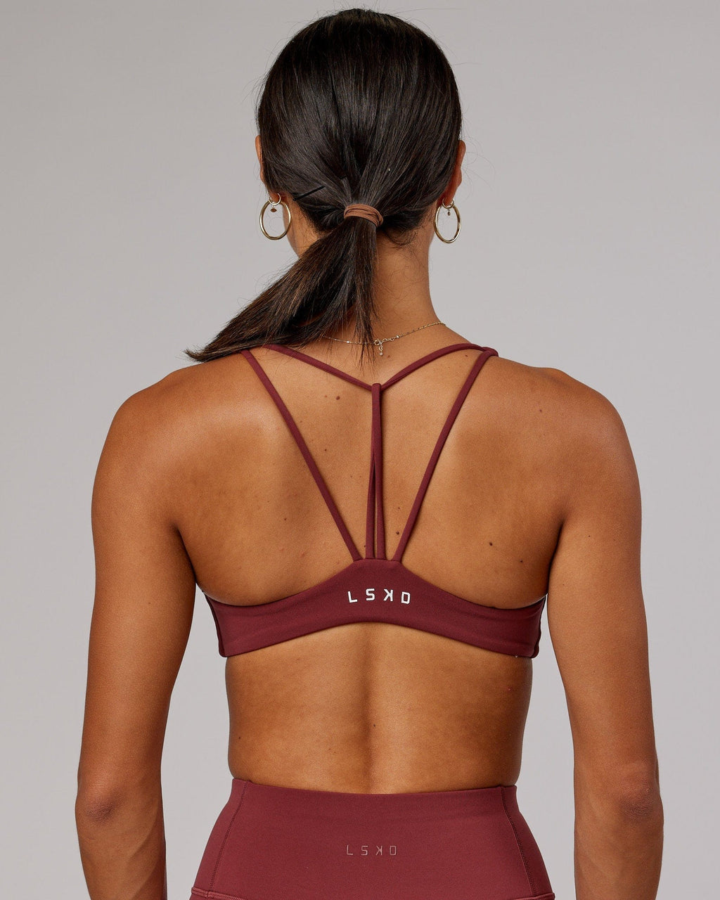Model wearing Agile Sports Bra - Apple Berry