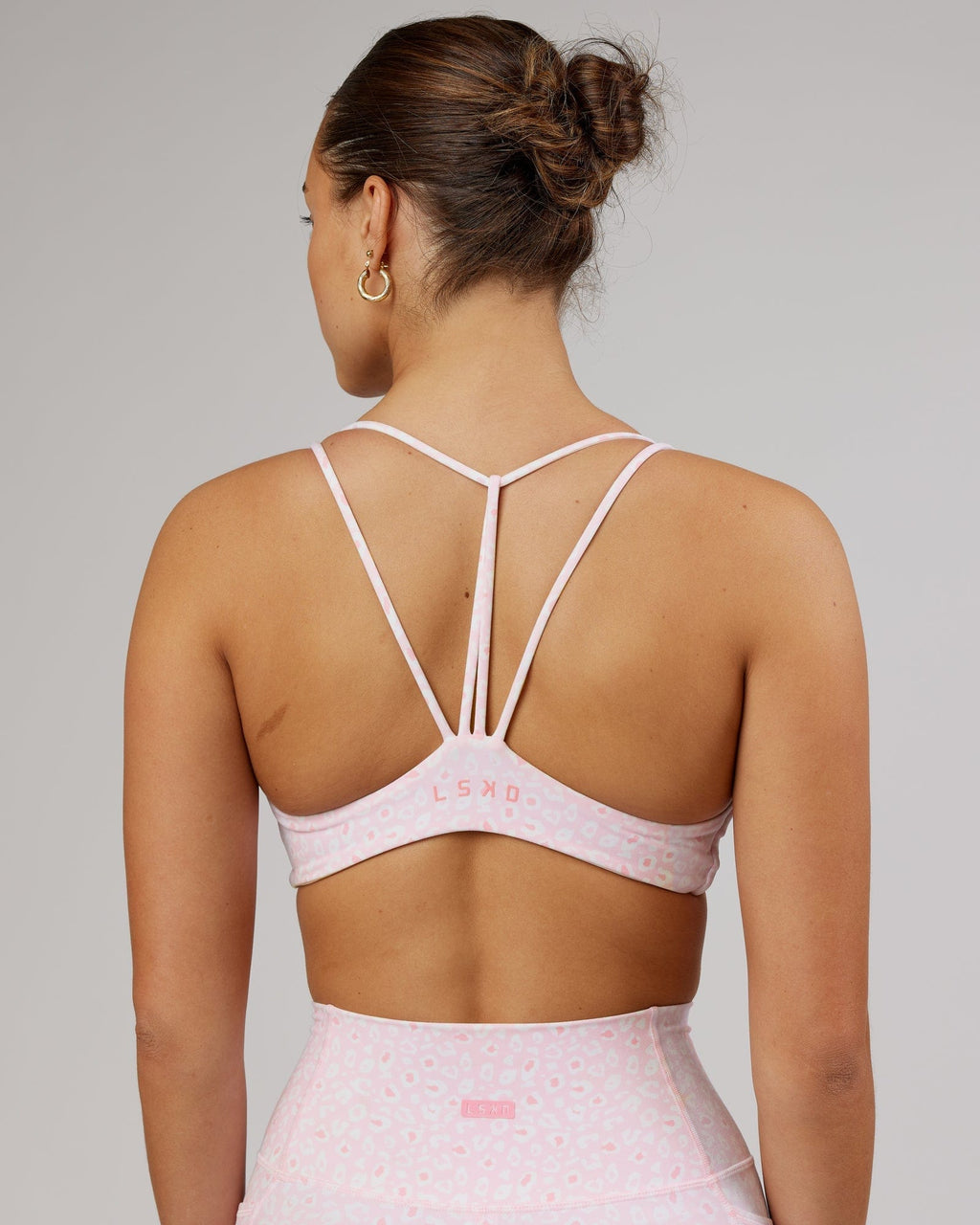 Model wearing Agile Sports Bra - Blush Leopard