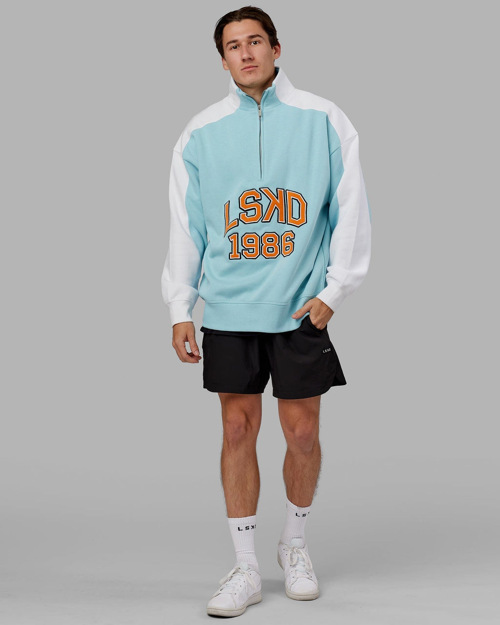 Model wearing Alumni 1/4 Zip Sweater Oversize - Crystal Blue-Orange Peel