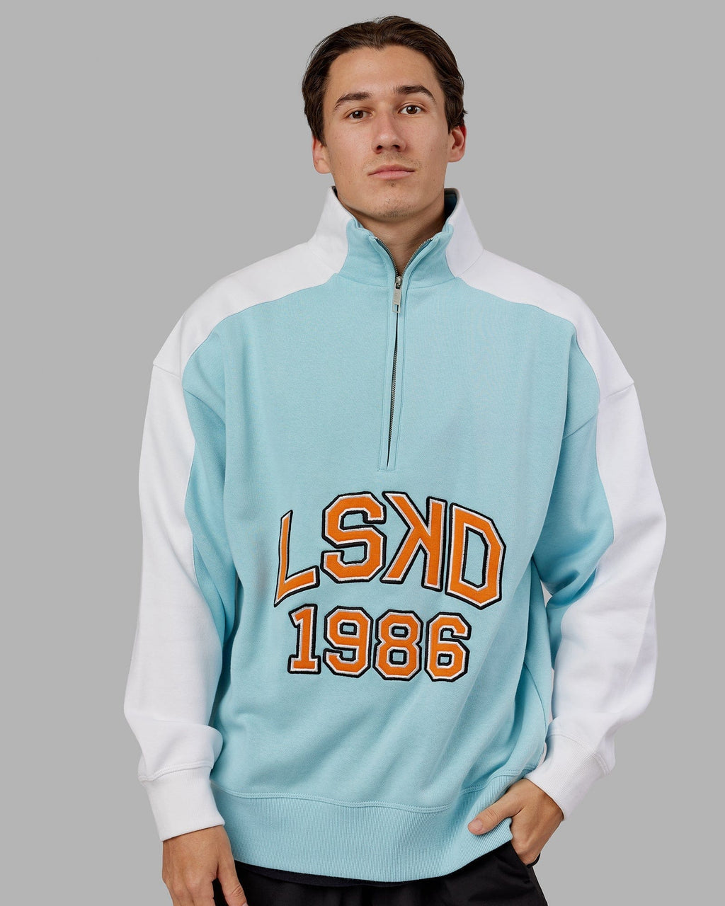 Model wearing Alumni 1/4 Zip Sweater Oversize - Crystal Blue-Orange Peel