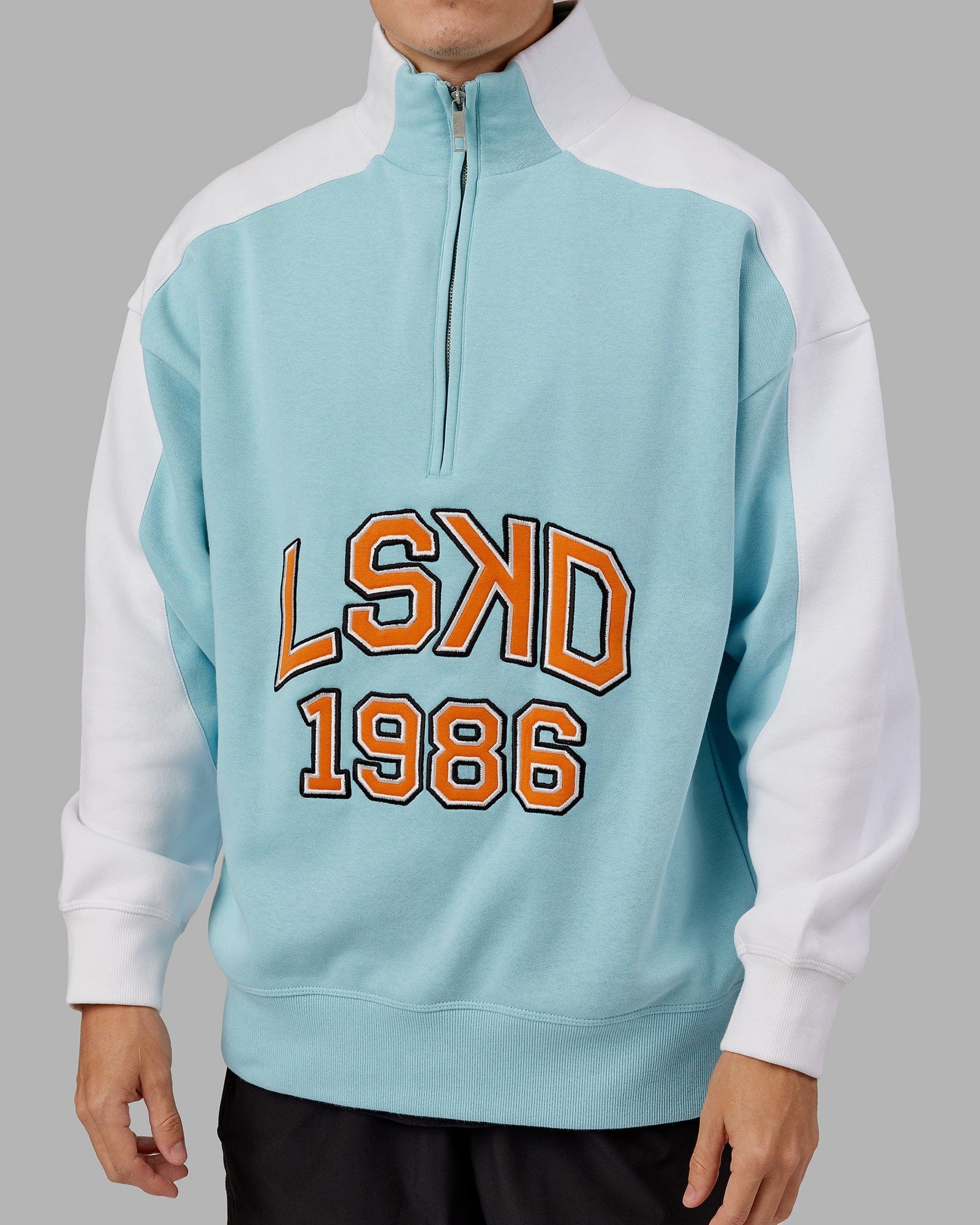 Model wearing Alumni 1/4 Zip Sweater Oversize - Crystal Blue-Orange Peel