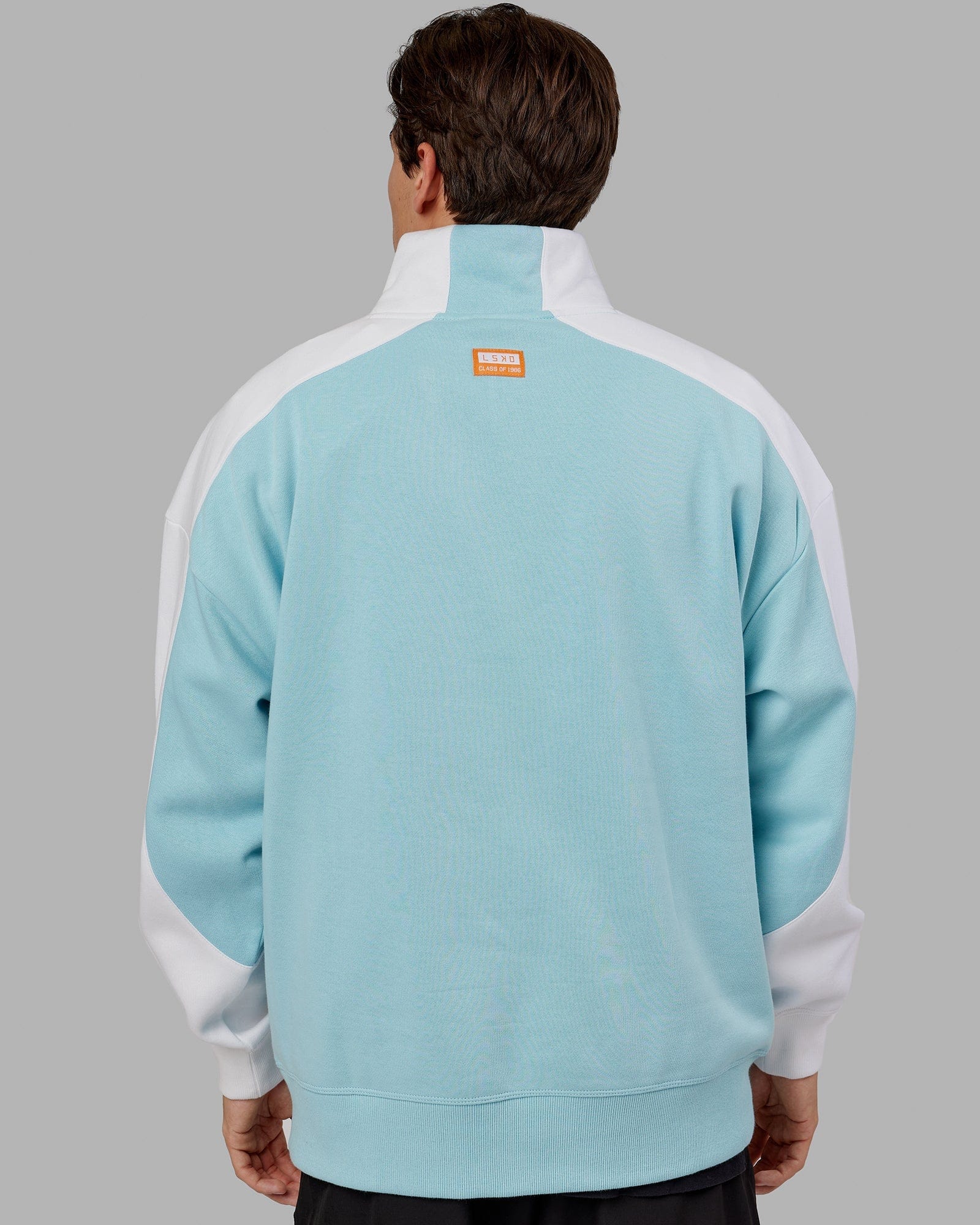 Model wearing Alumni 1/4 Zip Sweater Oversize - Crystal Blue-Orange Peel