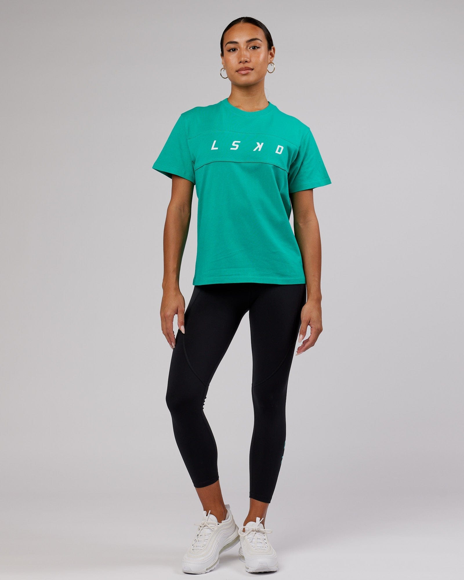 Model wearing Ascent Tee - Hyper Teal