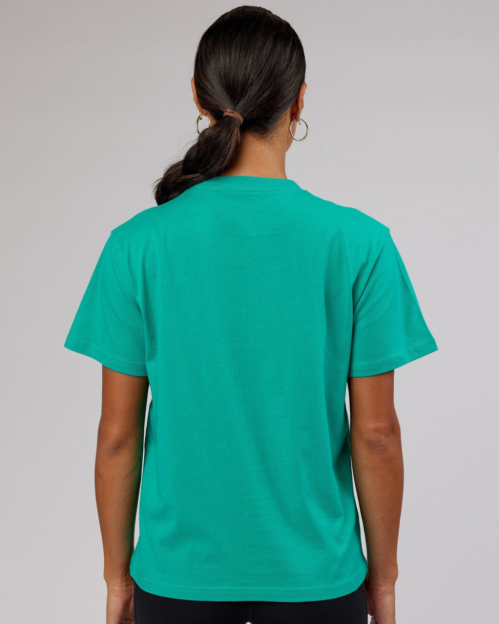 Model wearing Ascent Tee - Hyper Teal