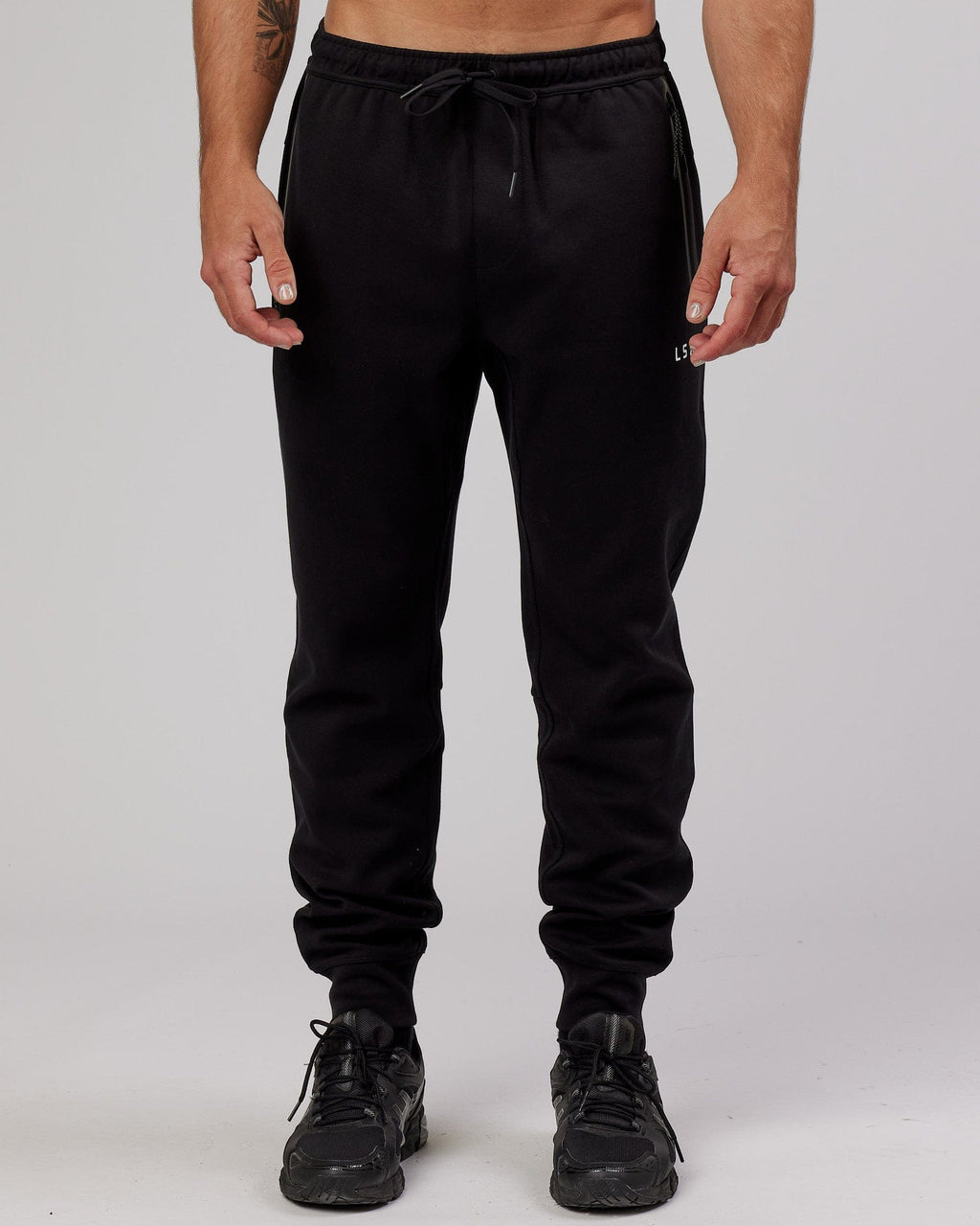 Model wearing Athlete ForgedFleece Zip Trackpant - Black