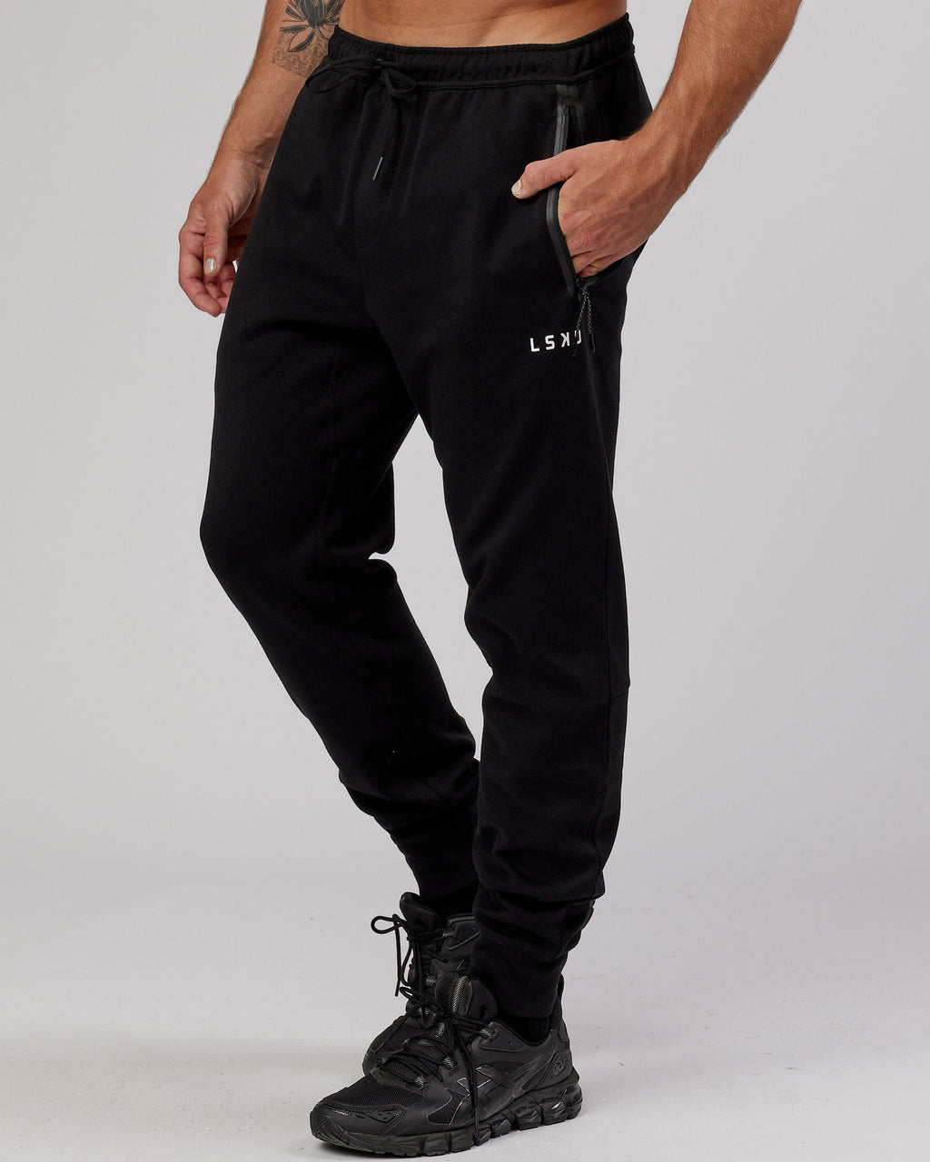 Model wearing Athlete ForgedFleece Zip Trackpant - Black