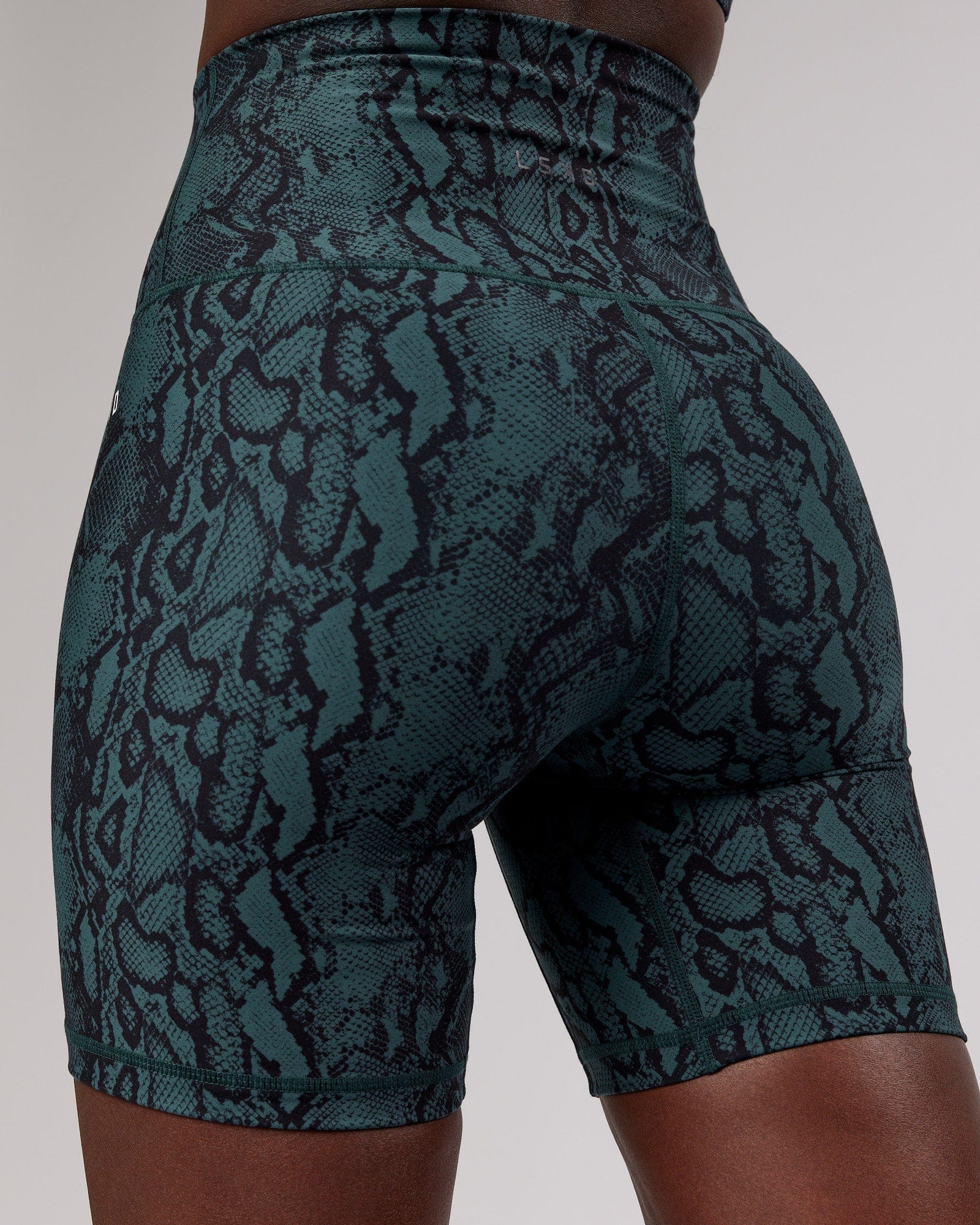Model wearing Base Mid Short Tight - Forest Snakeskin