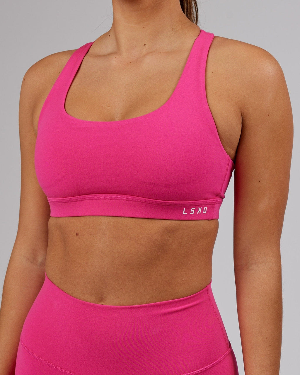 Model wearing Base Sports Bra - Magenta