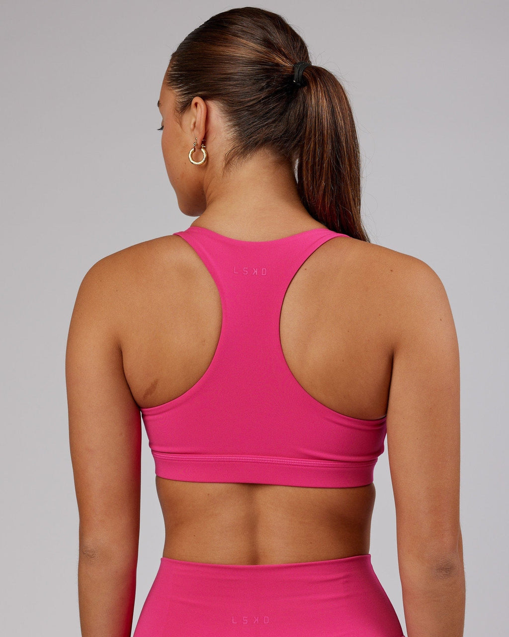 Model wearing Base Sports Bra - Magenta