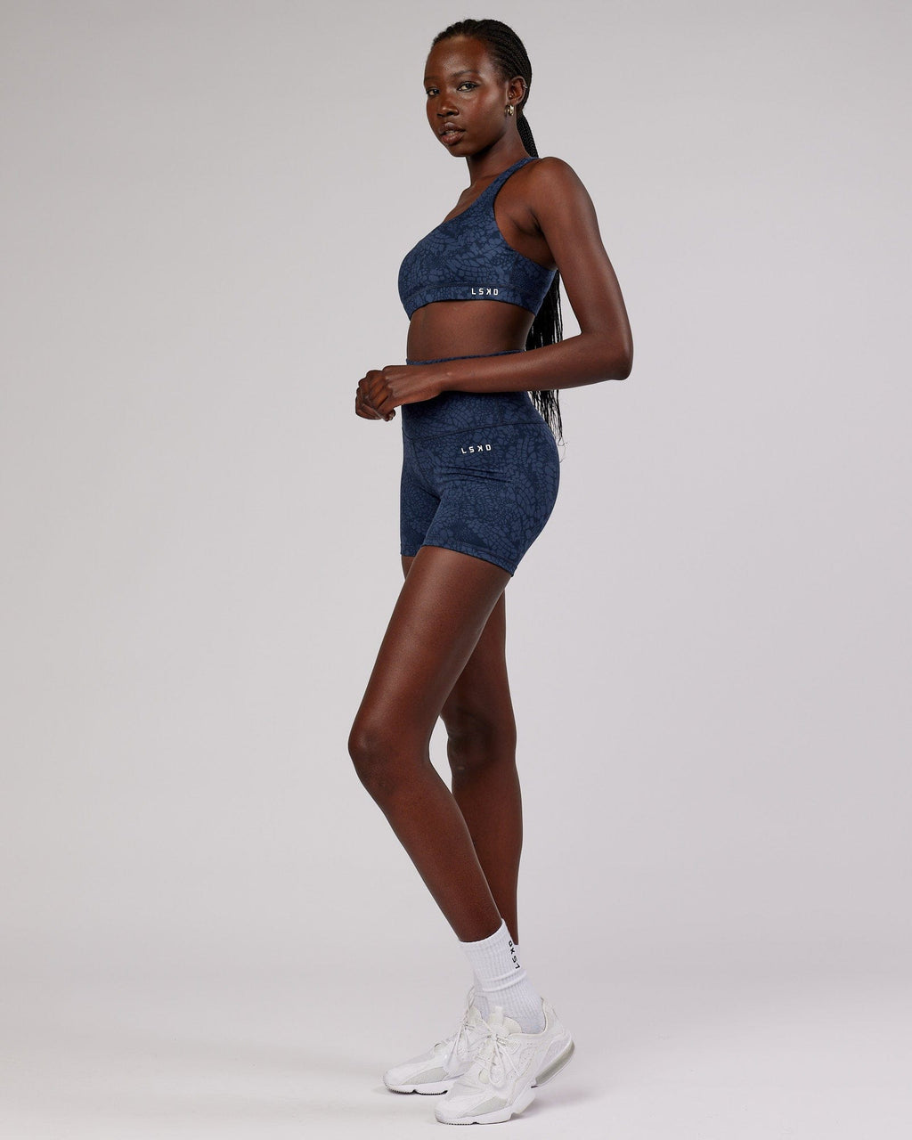 Model wearing Base Sports Bra - Navy Mamba