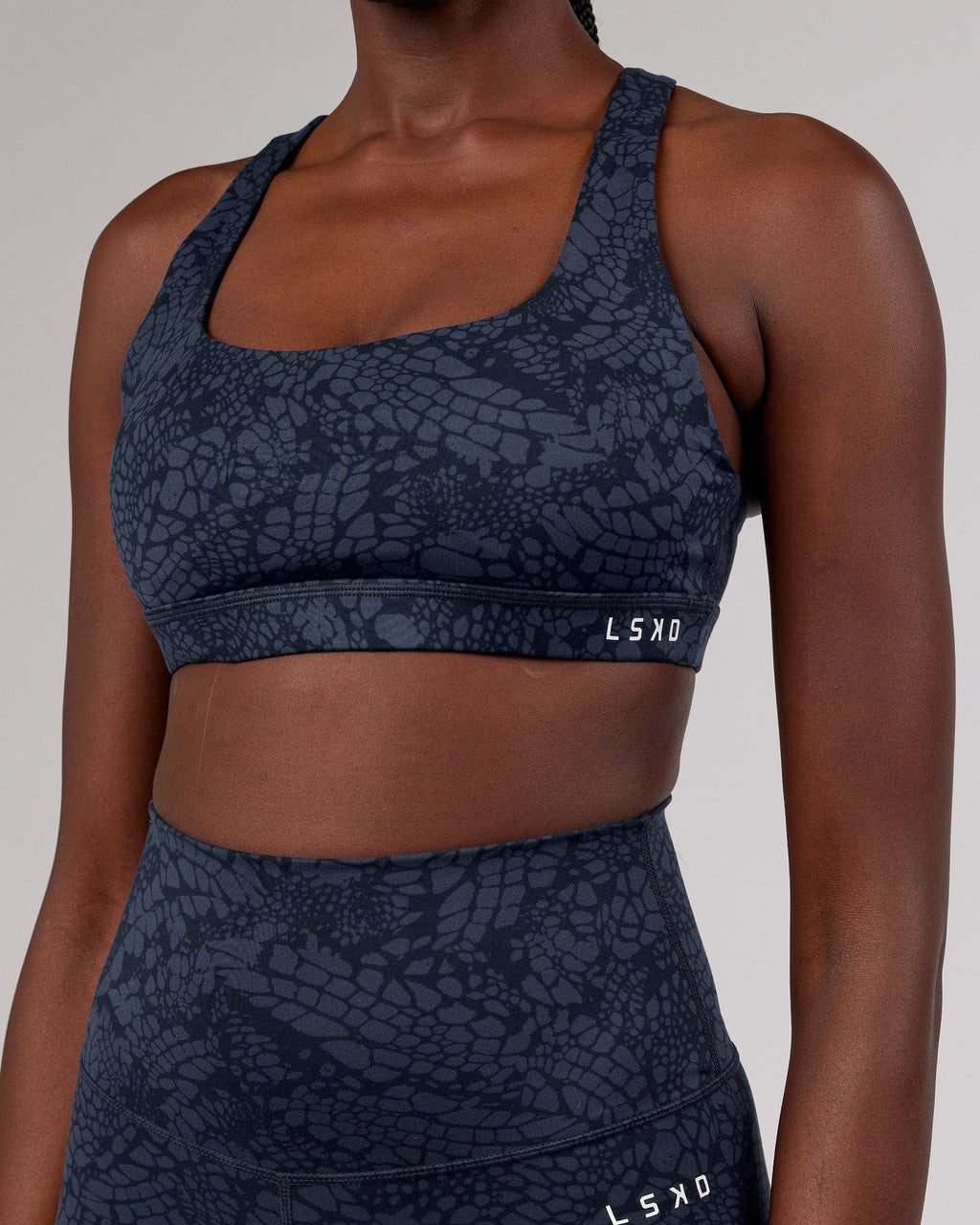 Model wearing Base Sports Bra - Navy Mamba