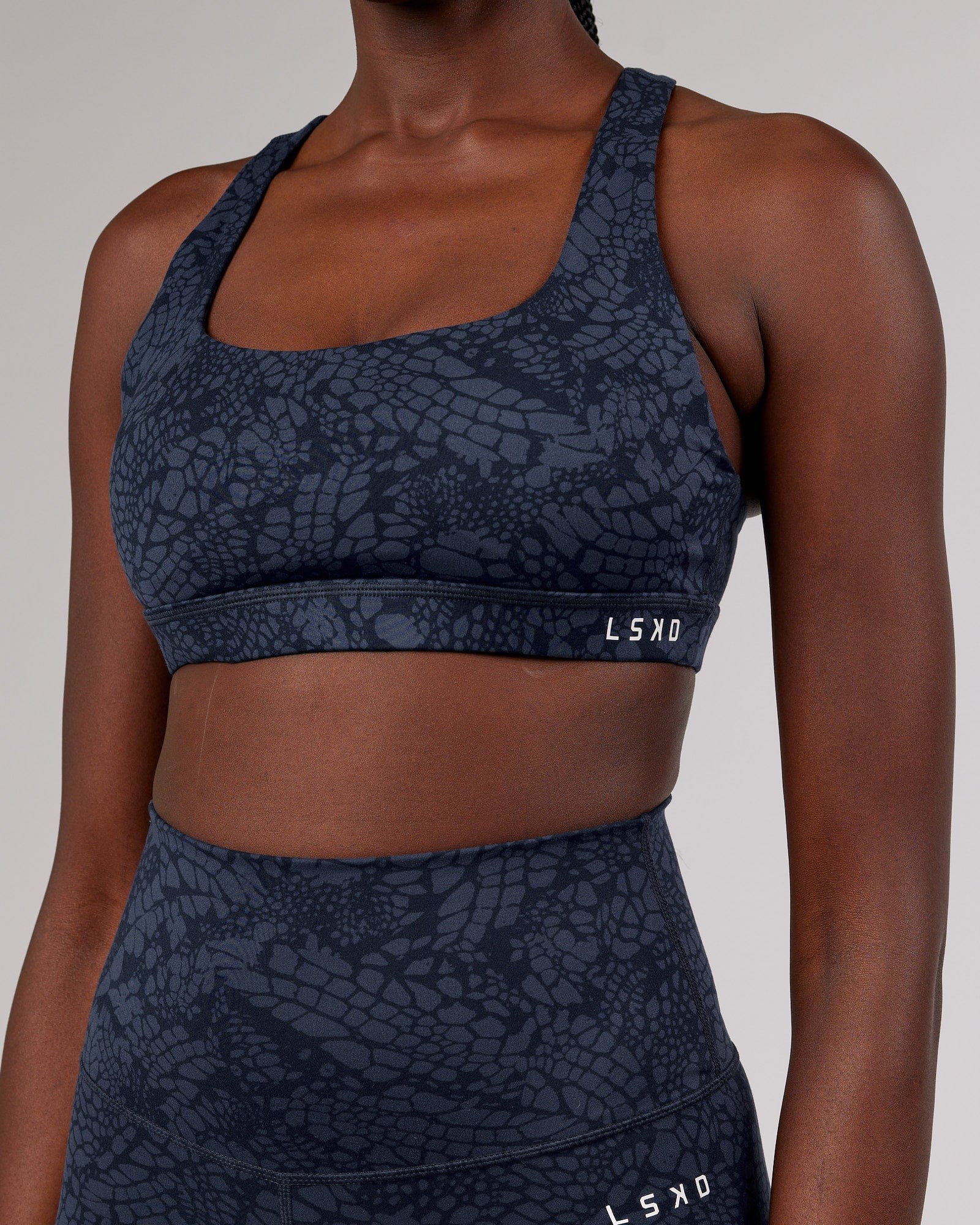 Model wearing Base Sports Bra - Navy Mamba