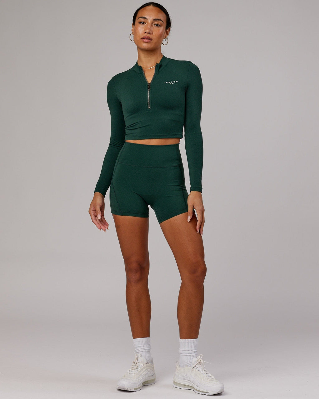 Model wearing Bend X-Short Tight - Vital Green