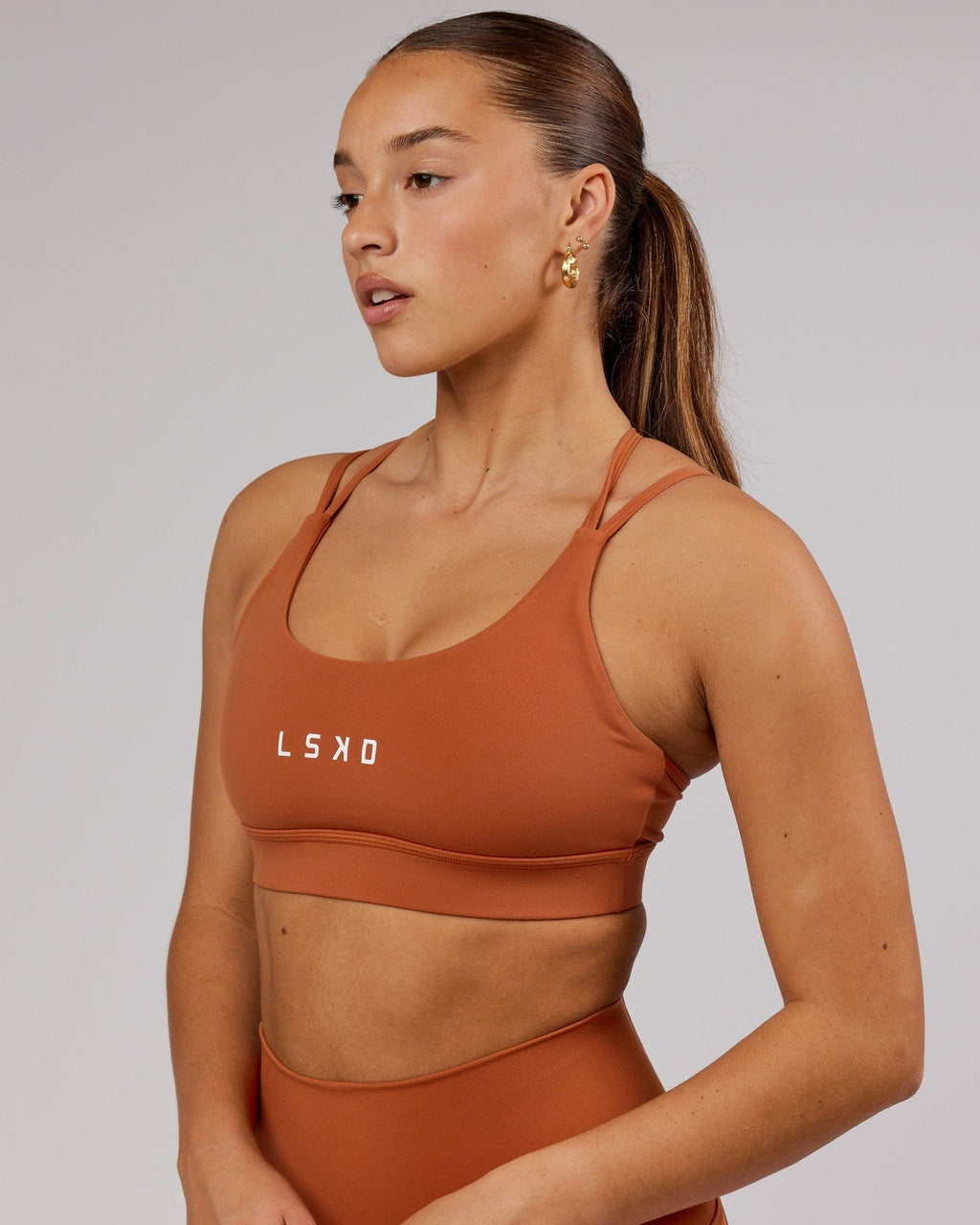 Model wearing Bridge Sports Bra - Auburn