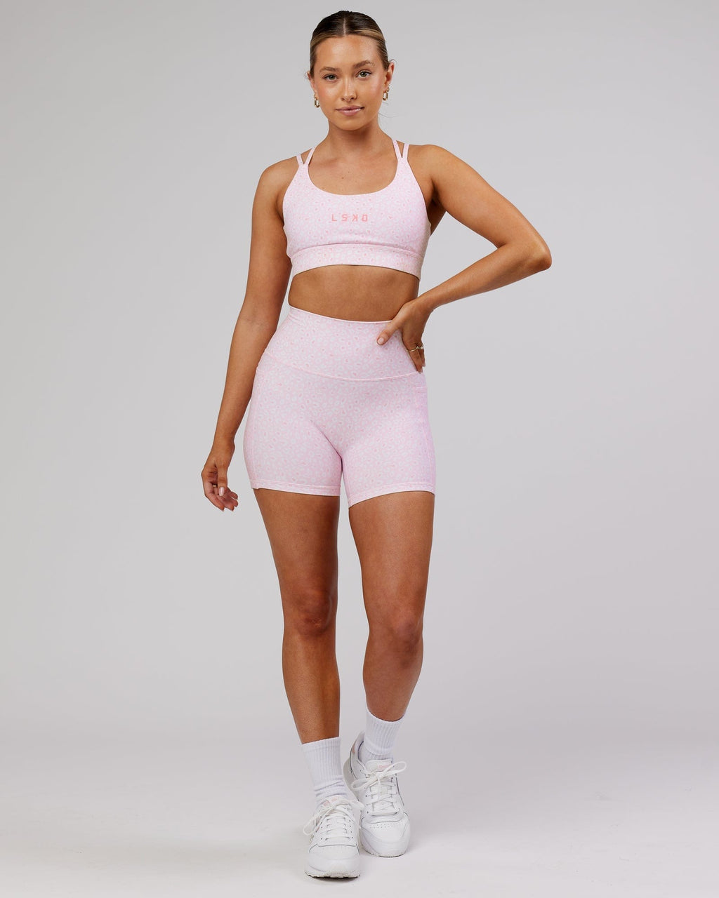 Model wearing Bridge Sports Bra - Blush Leopard