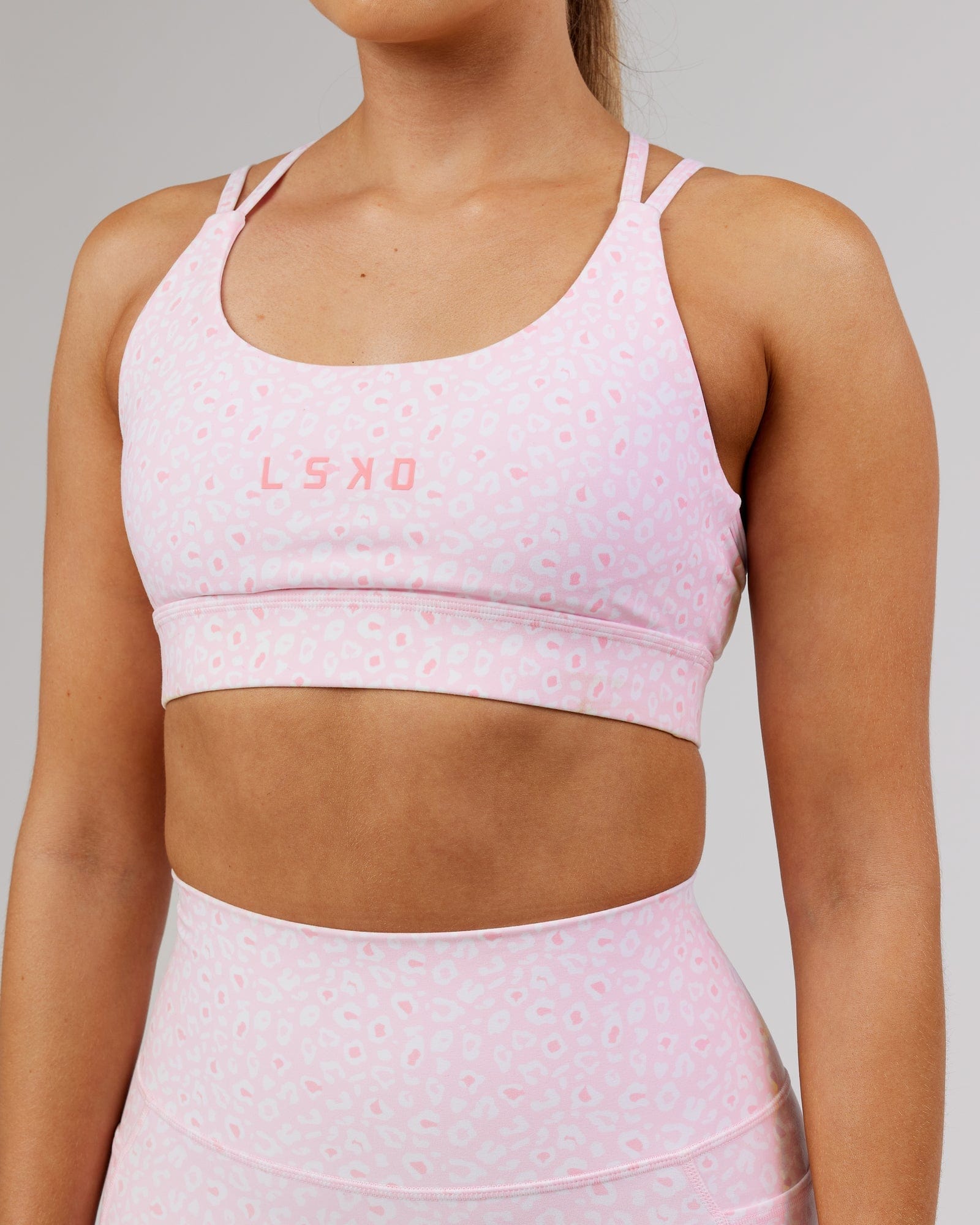Model wearing Bridge Sports Bra - Blush Leopard