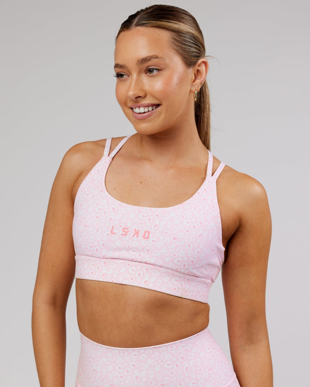 Model wearing Bridge Sports Bra - Blush Leopard