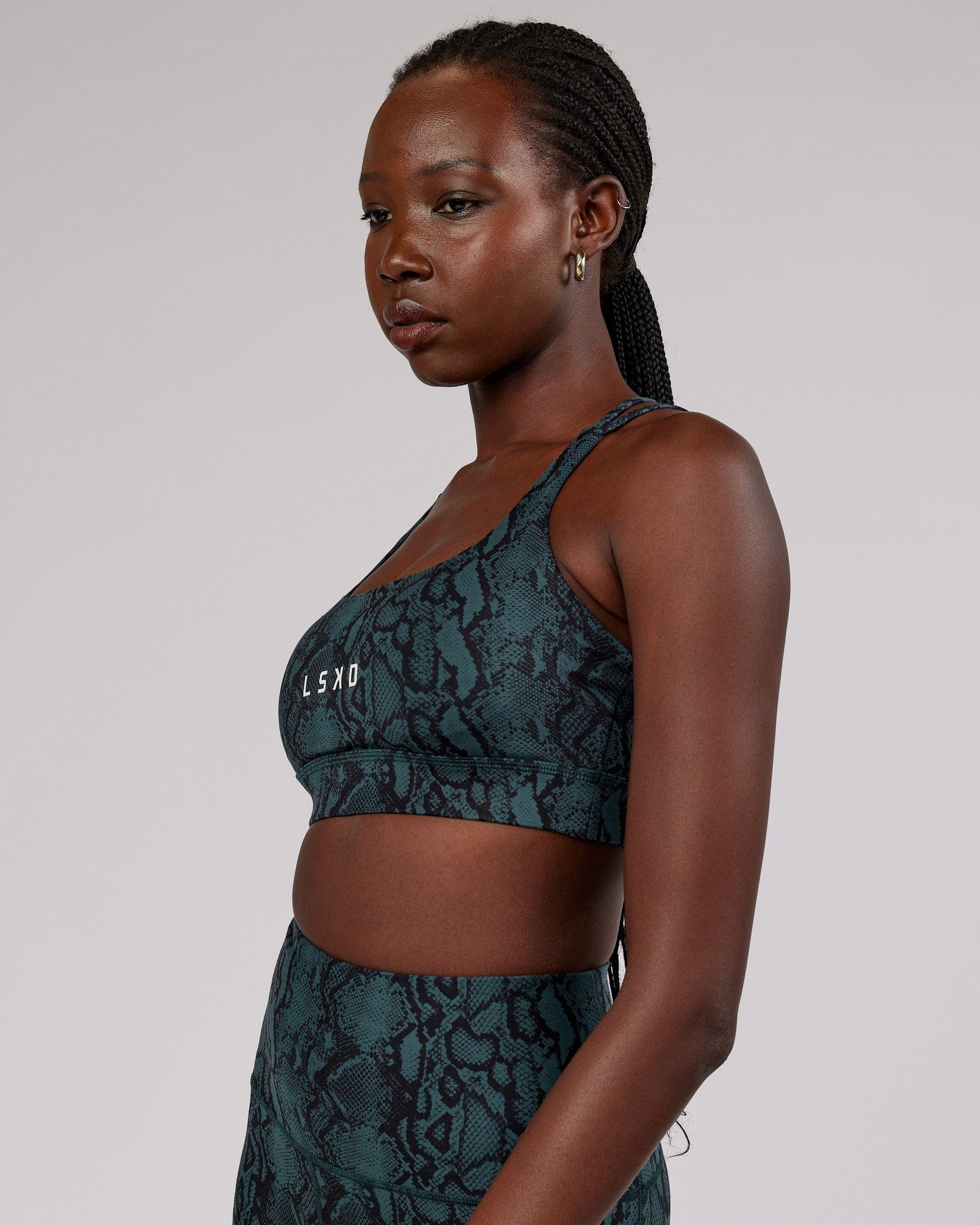 Model wearing Bridge Sports Bra - Forest Snakeskin