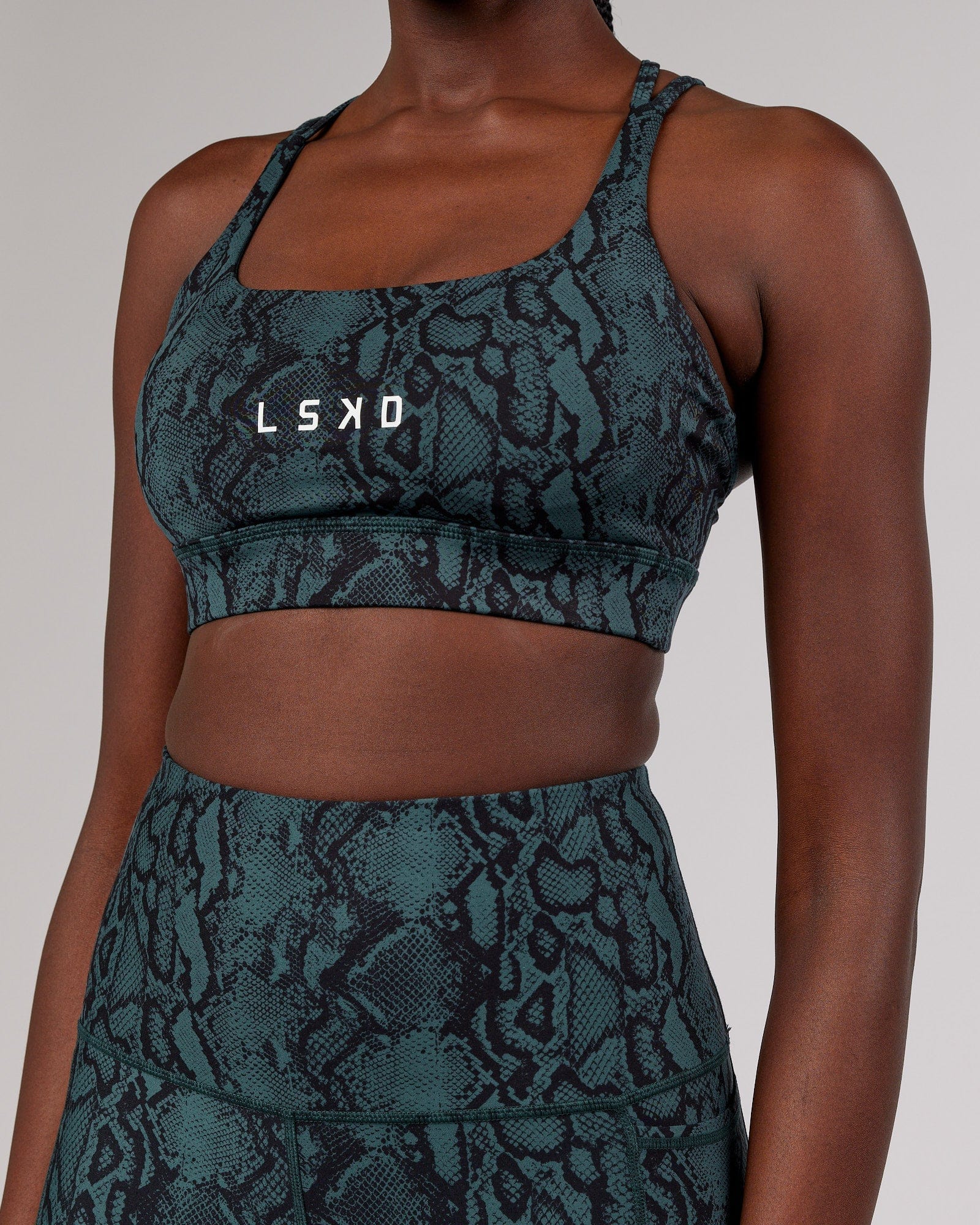 Model wearing Bridge Sports Bra - Forest Snakeskin