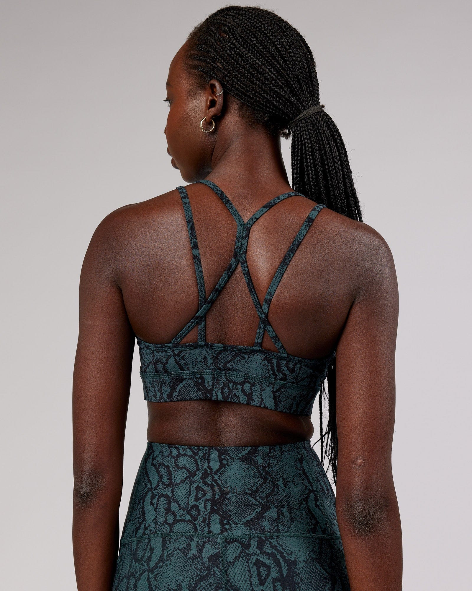 Model wearing Bridge Sports Bra - Forest Snakeskin