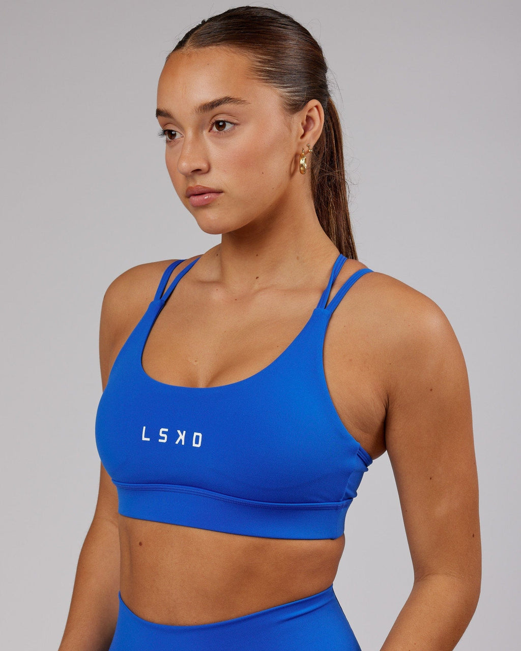 Model wearing Bridge Sports Bra - Strong Blue