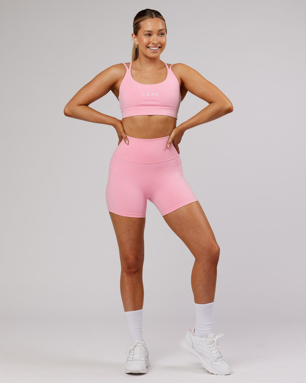 Model wearing Bridge Sports Bra - Pink Frosting