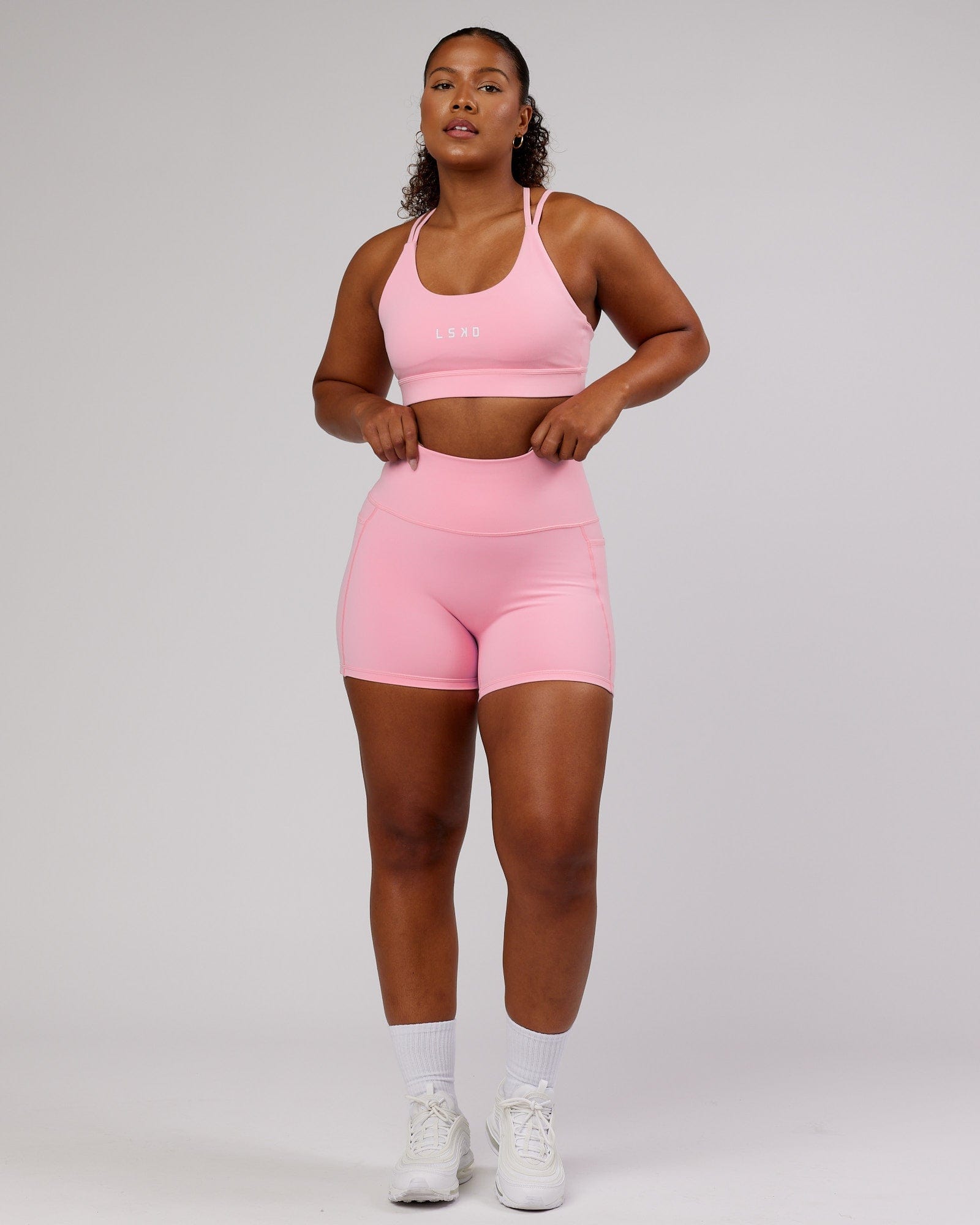 Model wearing Bridge Sports Bra - Pink Frosting