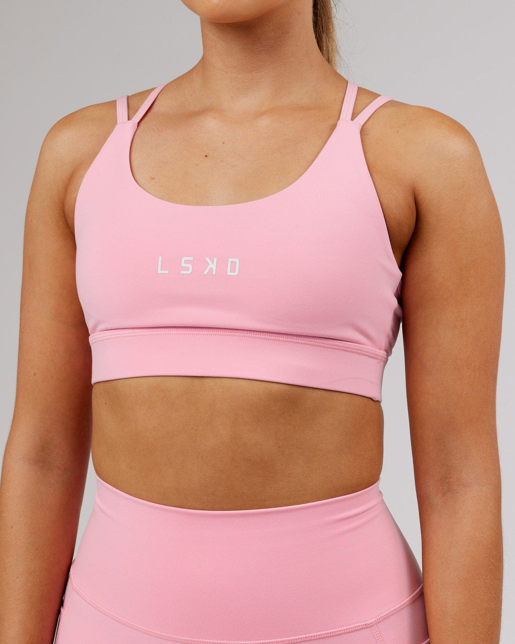 Model wearing Bridge Sports Bra - Pink Frosting
