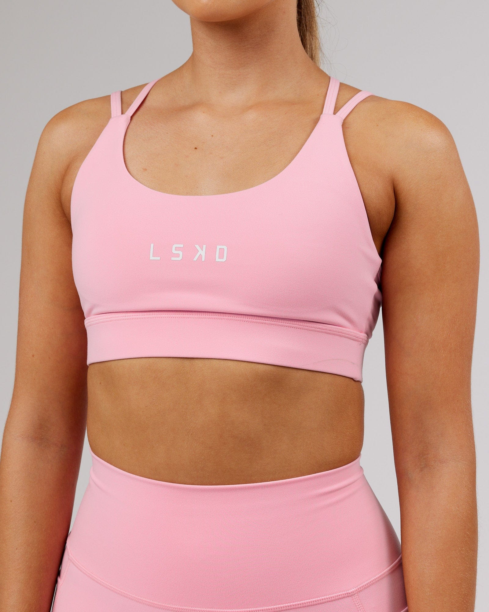 Model wearing Bridge Sports Bra - Pink Frosting