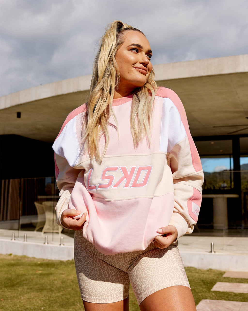 Model wearing Unisex Slam Oversize Sweater - Peach Multi