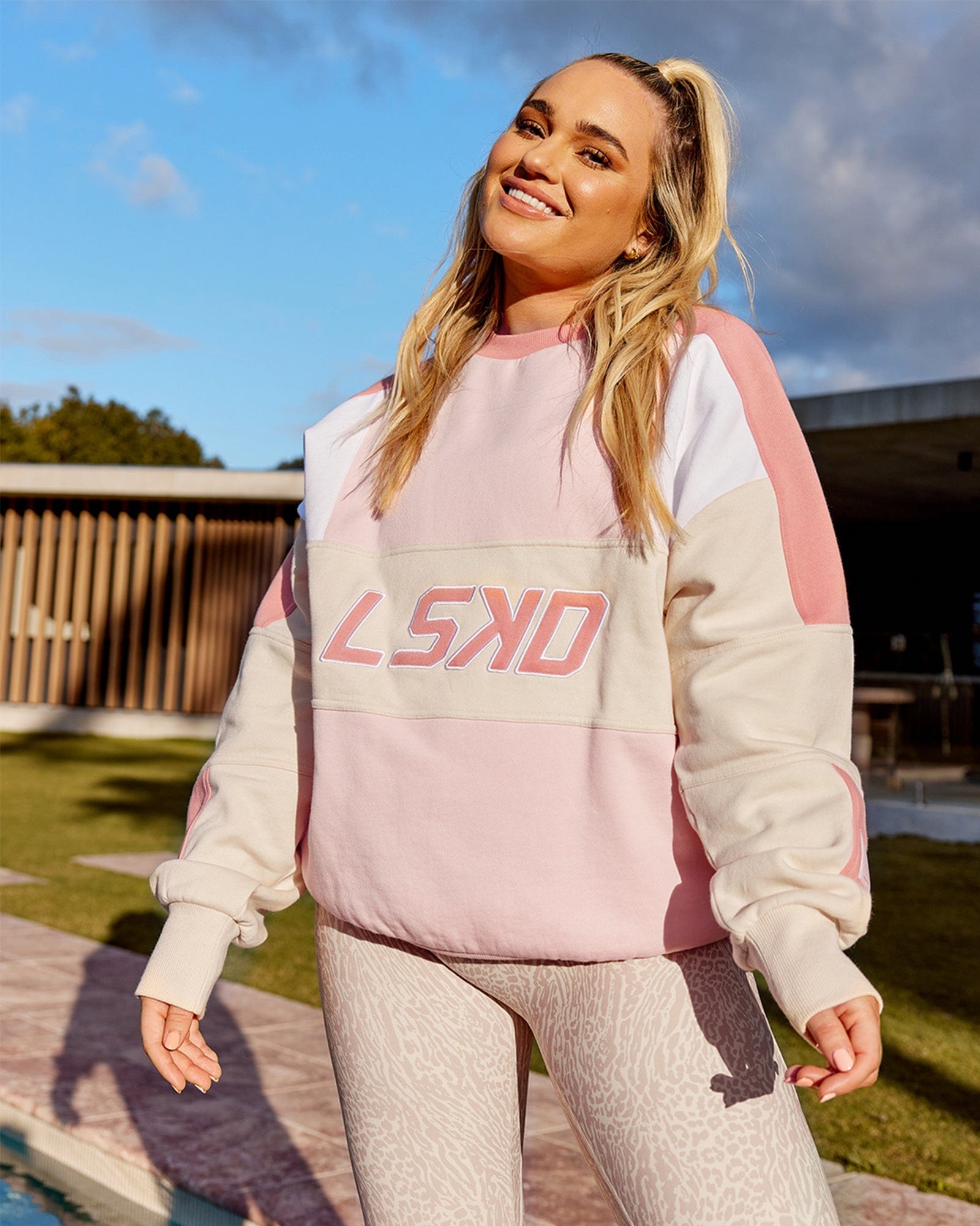 Model wearing Unisex Slam Oversize Sweater - Peach Multi