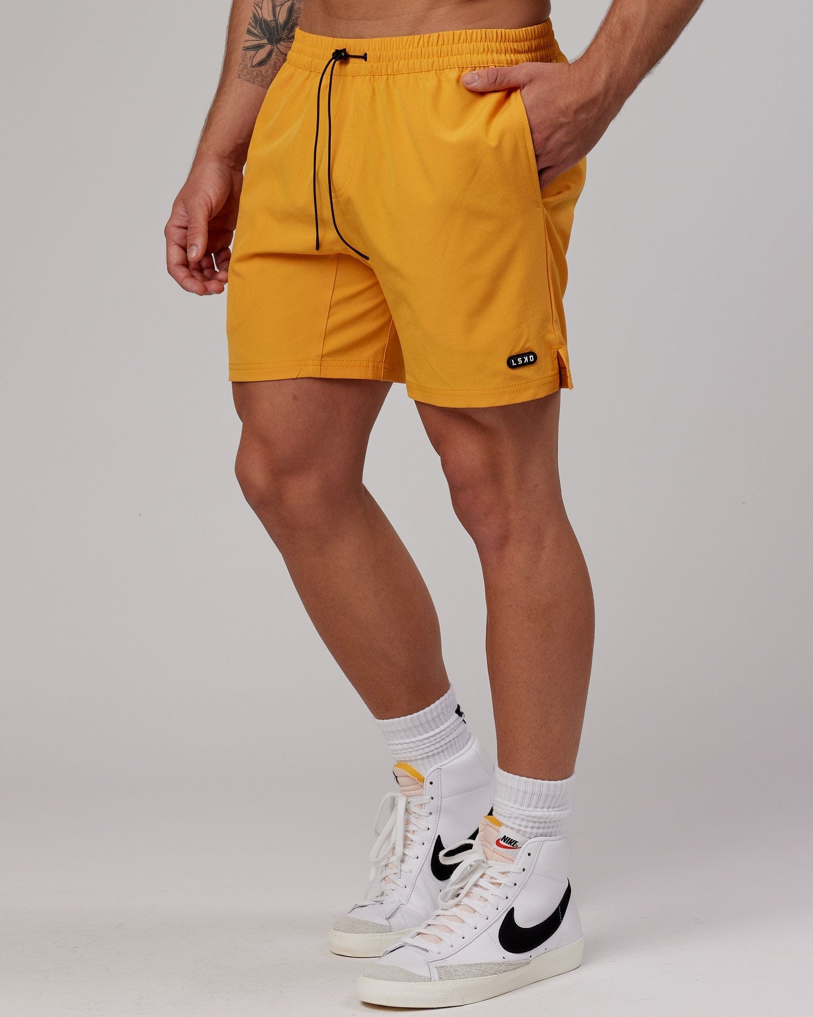 Model wearing Capsule 7" Performance Short - Butterscotch