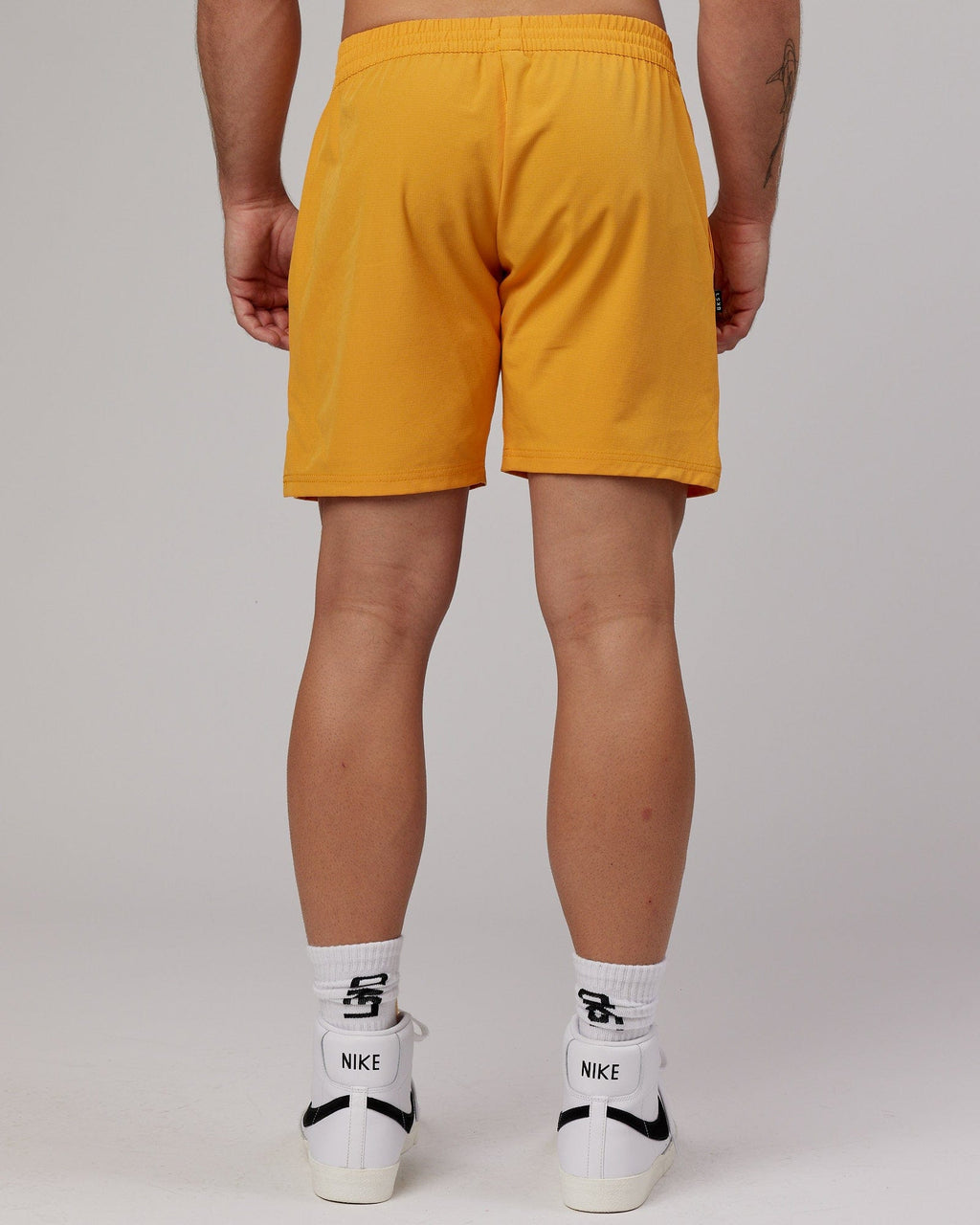 Model wearing Capsule 7" Performance Short - Butterscotch